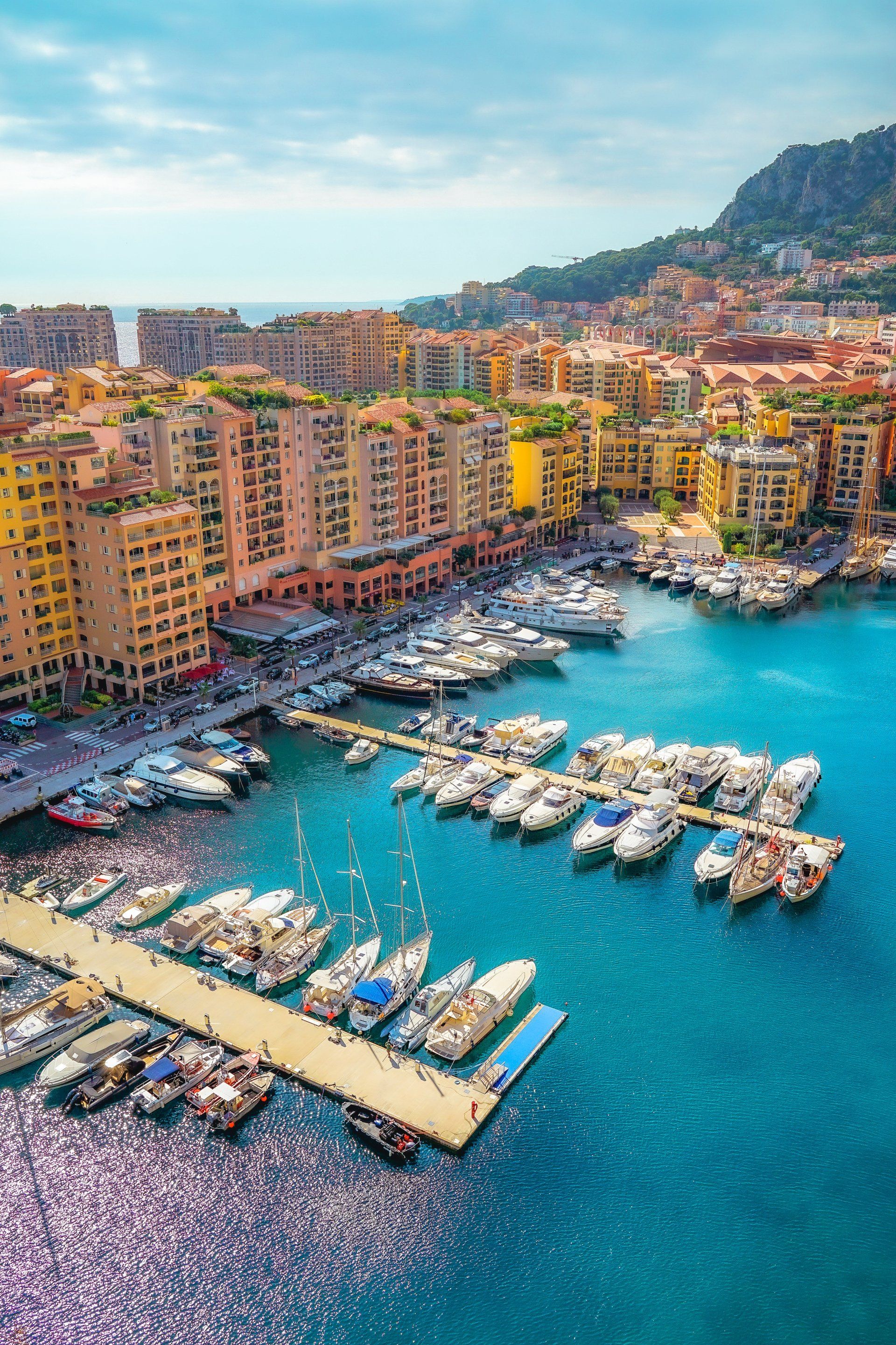 An aerial view of a marina filled with boats and buildings.