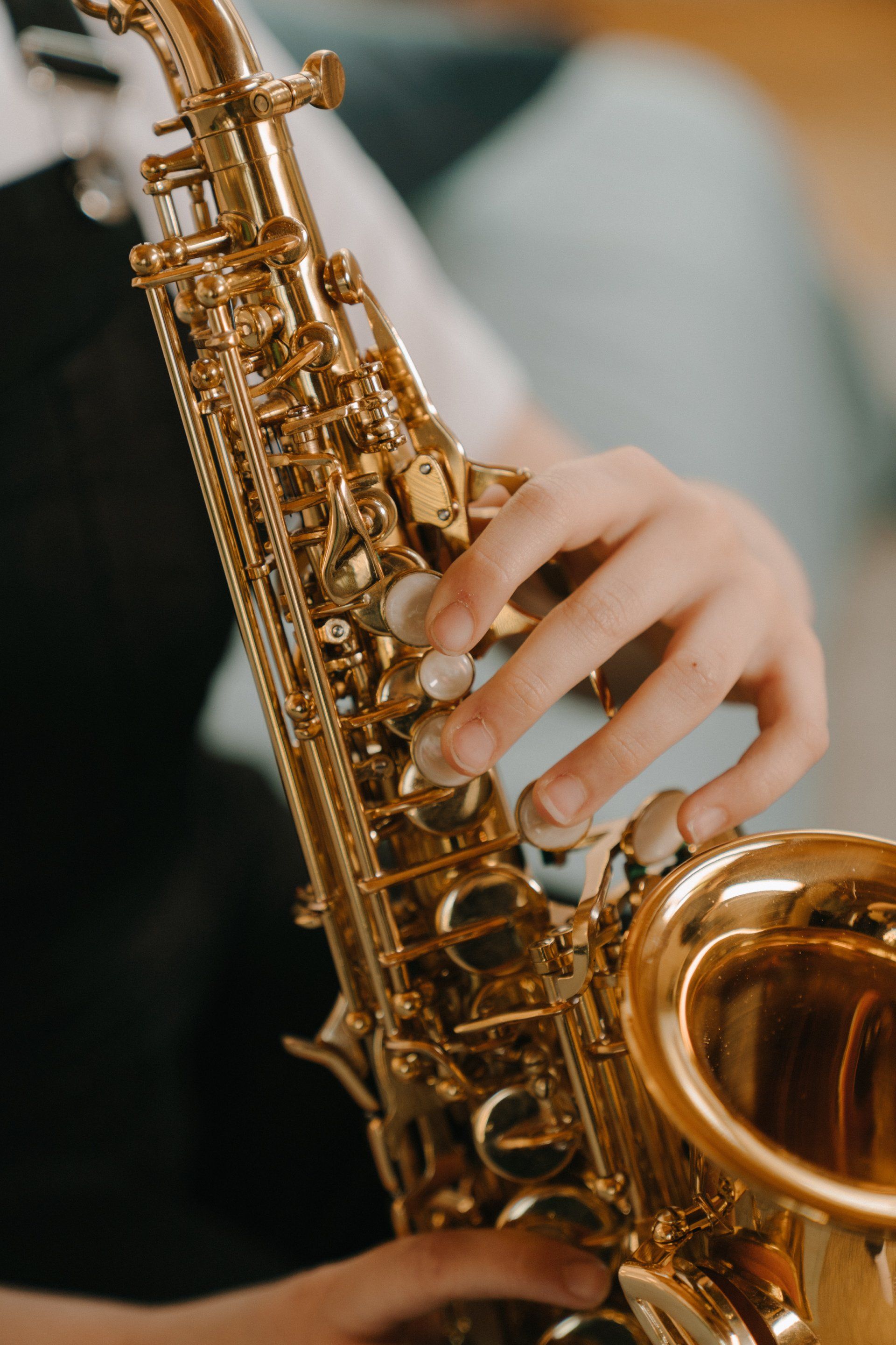 A close up of a person playing a saxophone.