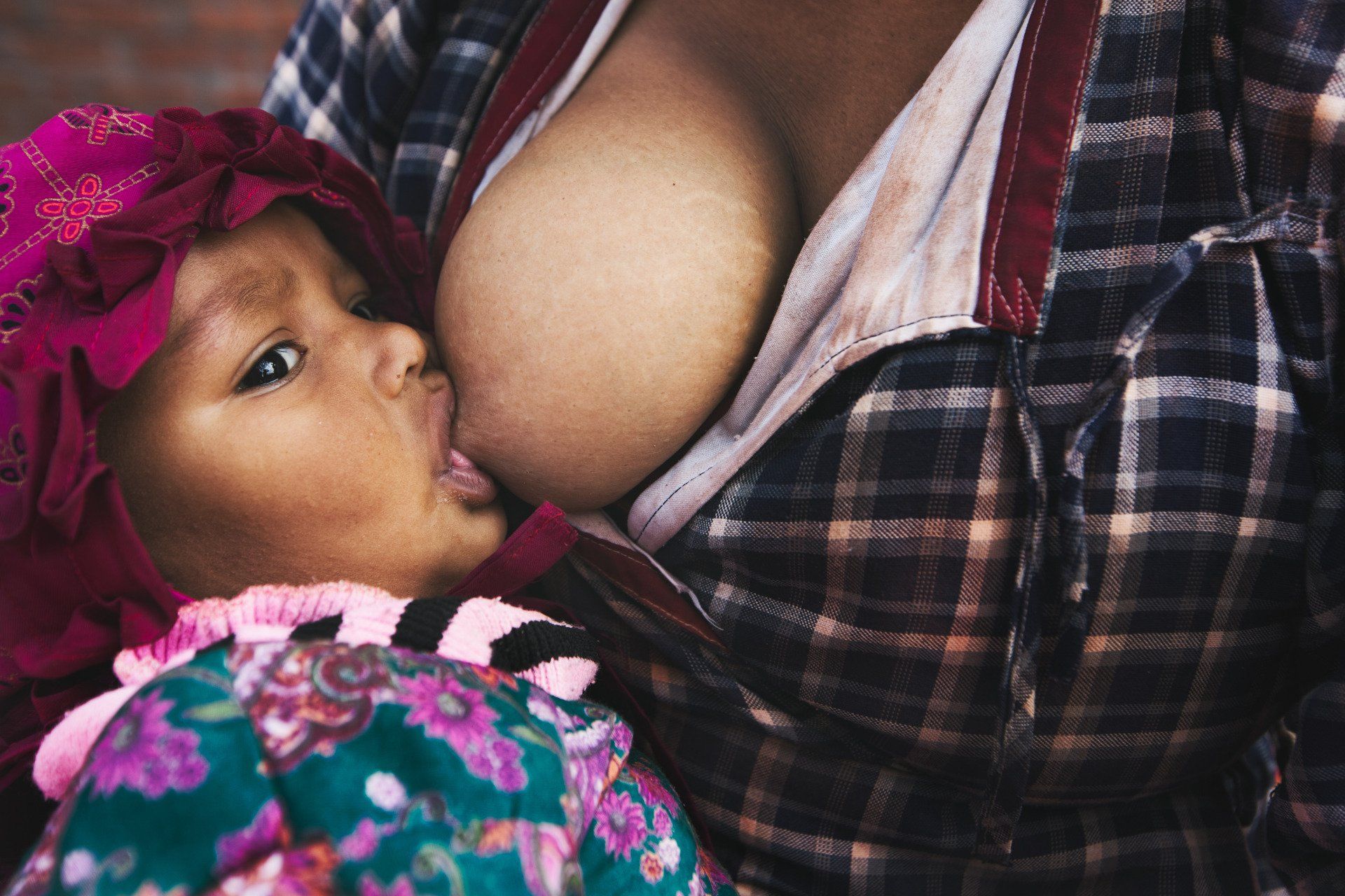 An African American  baby girl breastfeeding