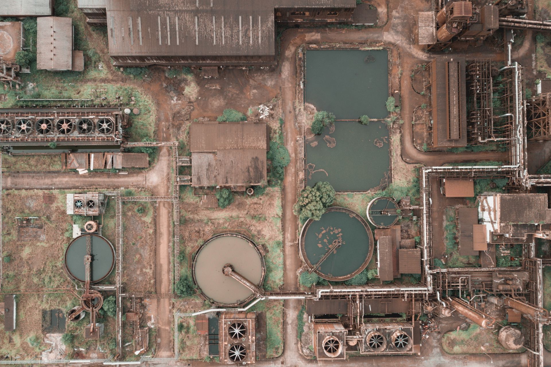 An aerial view of a large industrial area with lots of buildings and ponds.