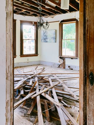 A room with a lot of wood laying on the floor