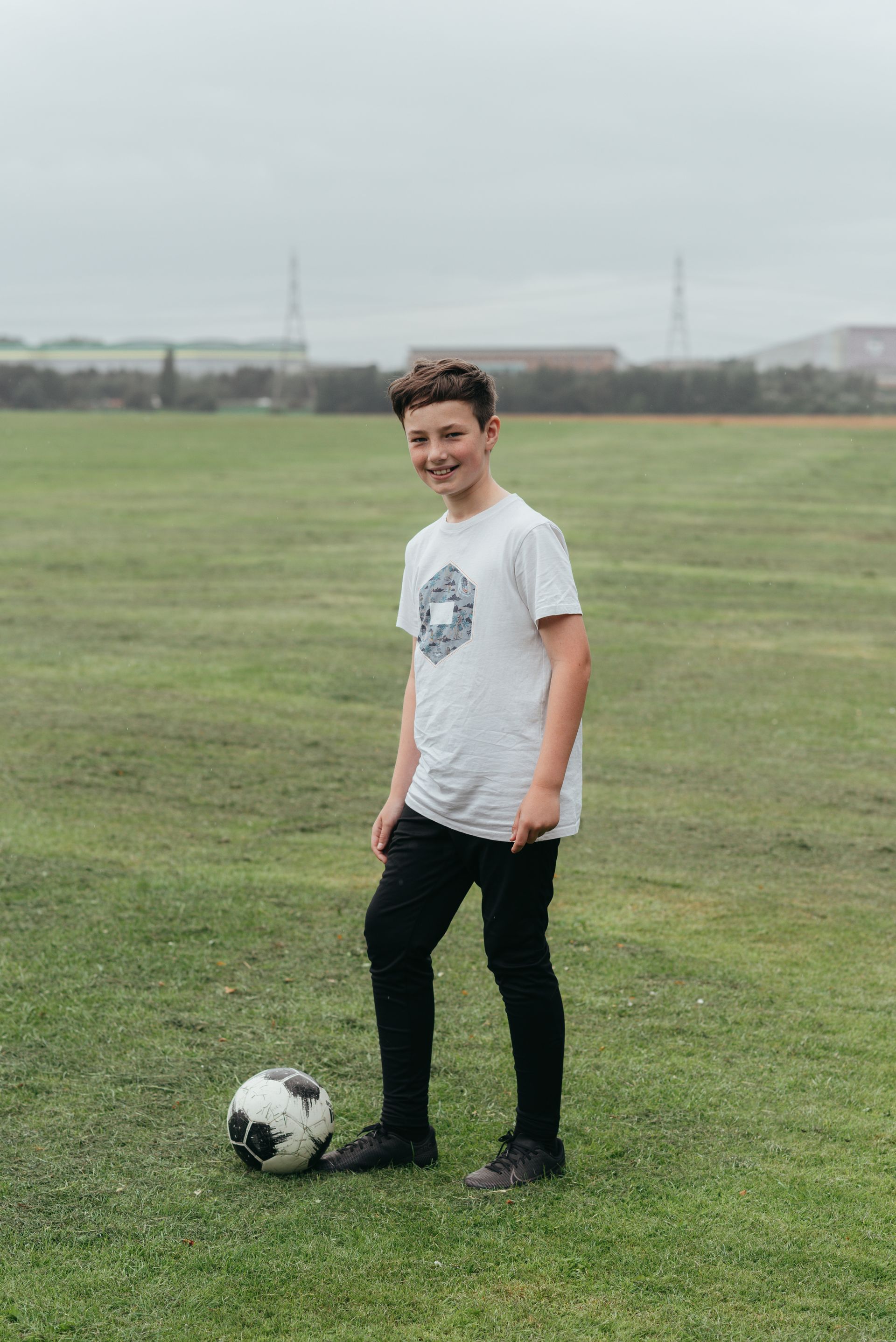 Young white  tween boy with soccer ball
