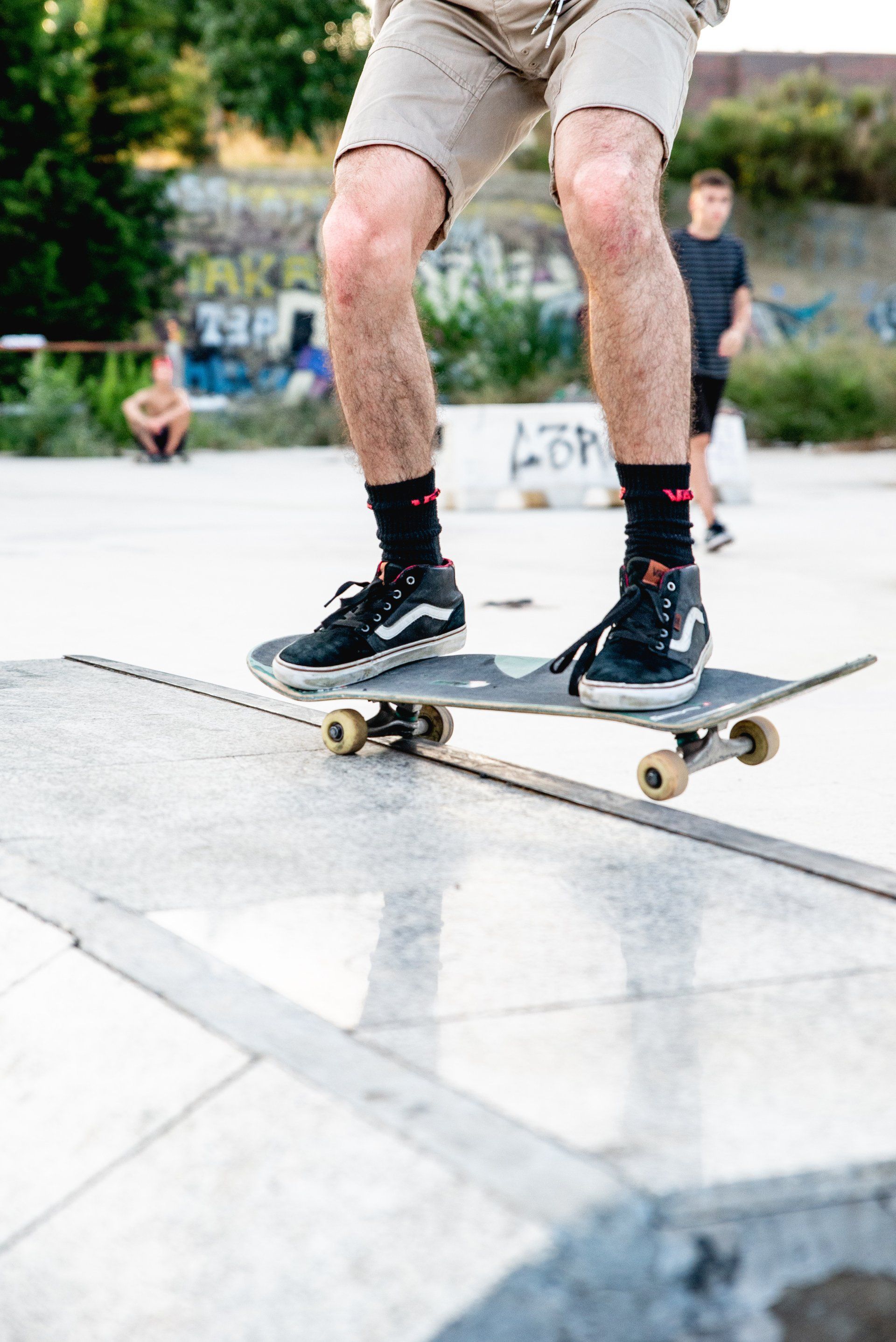 A man is riding a skateboard on a ramp in a skate park.