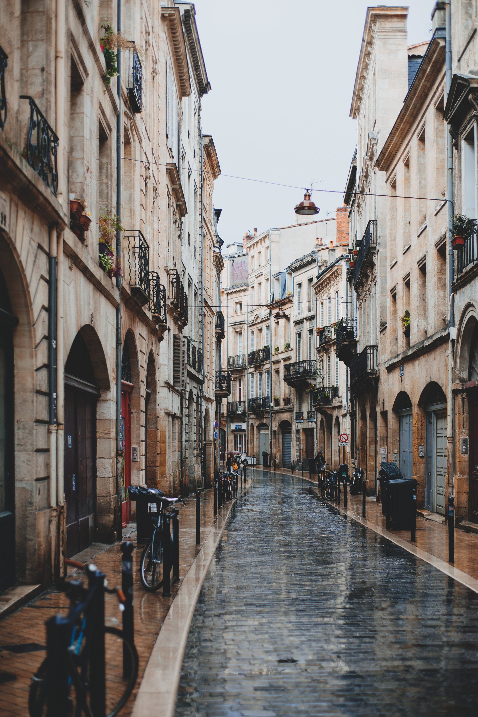 A narrow cobblestone street lined with building storefronts symbolic of a business website in marketing.  