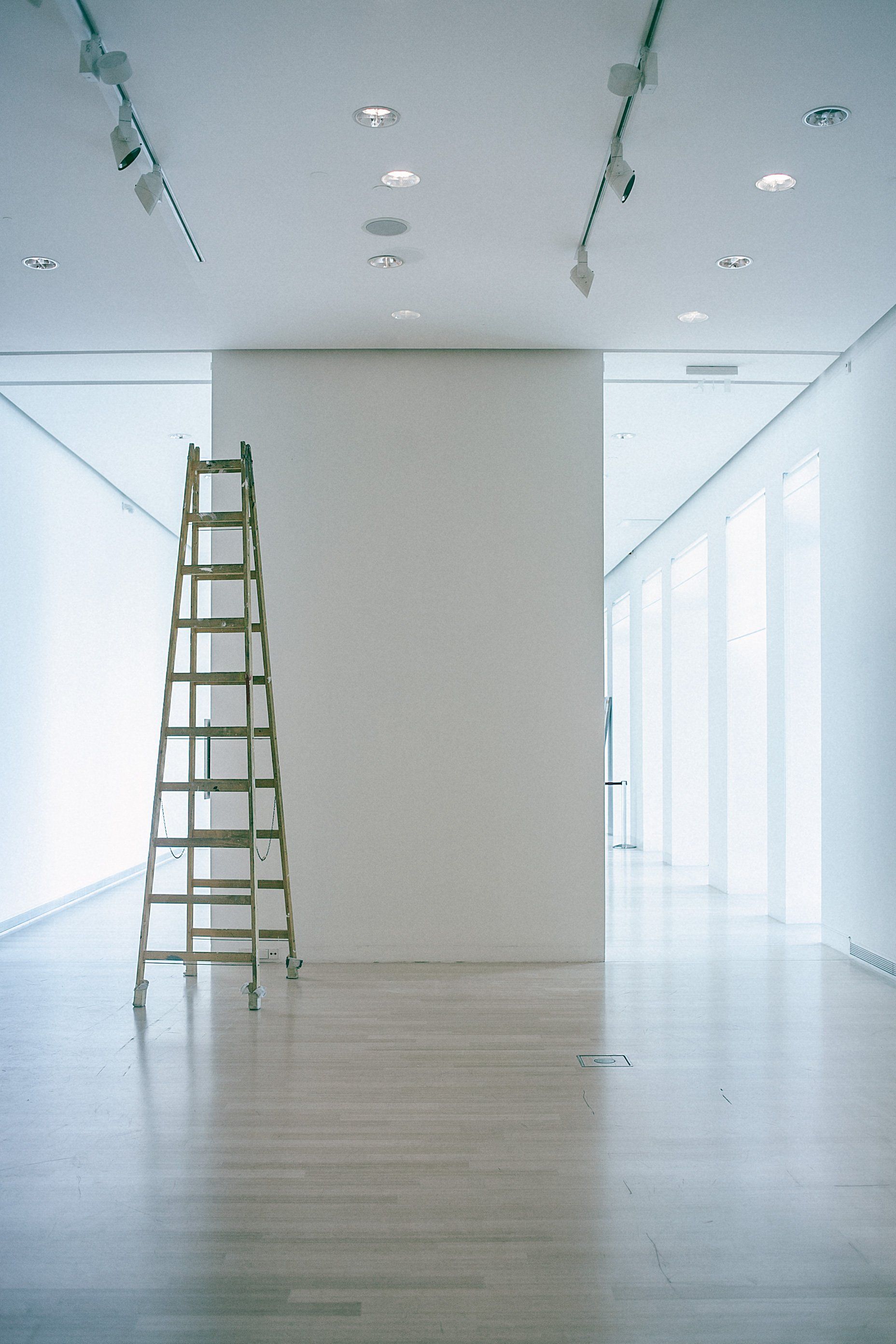 a ladder resting on a white wall