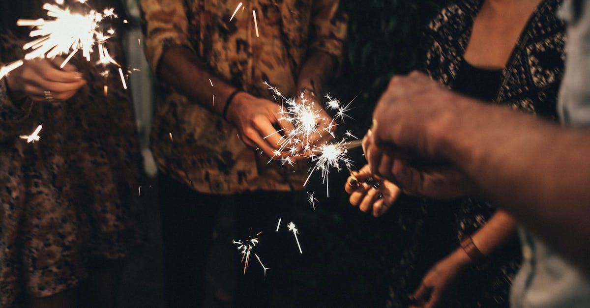 A group of people are holding sparklers in their hands.