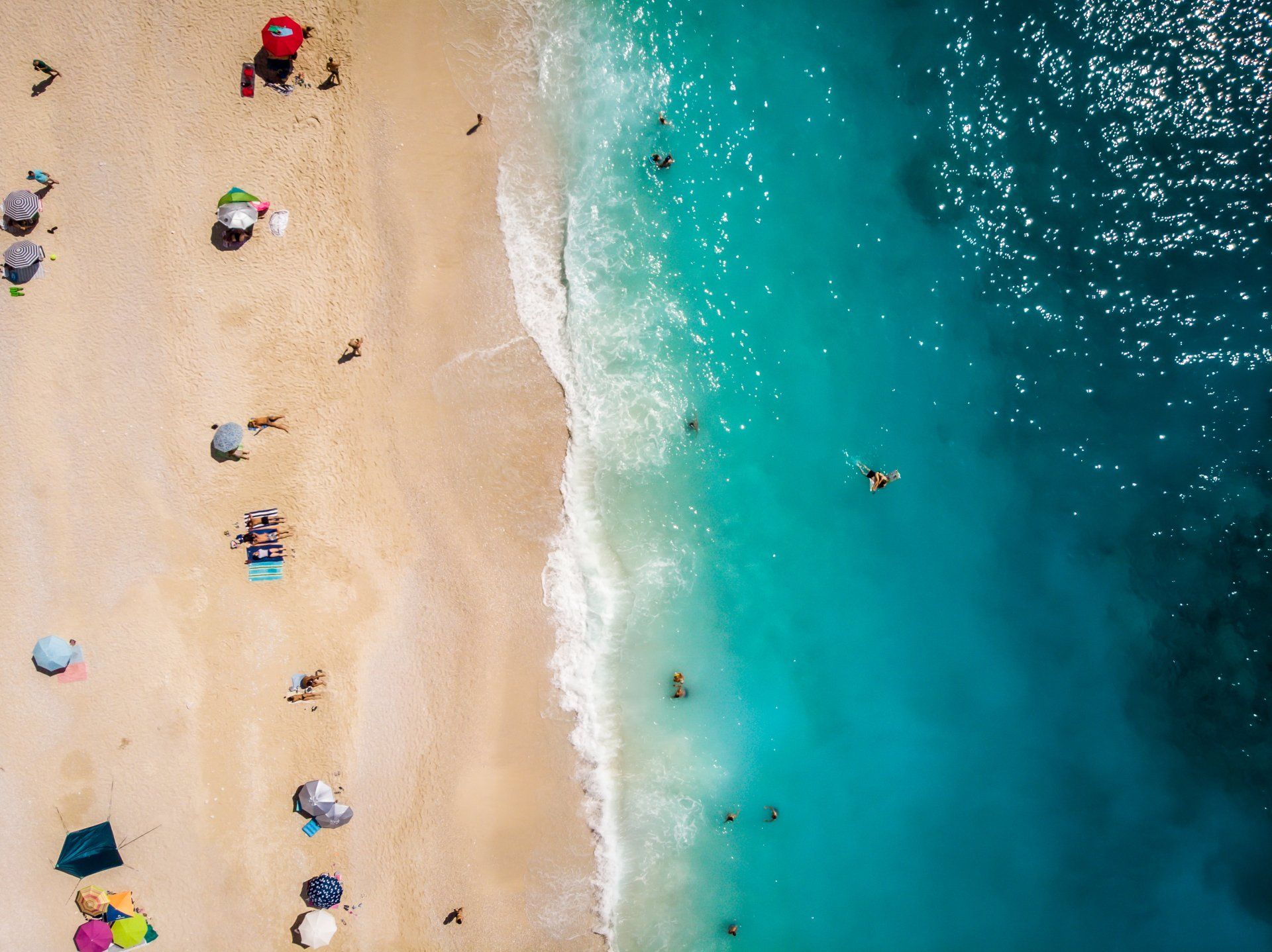 Drone image of beach with people 