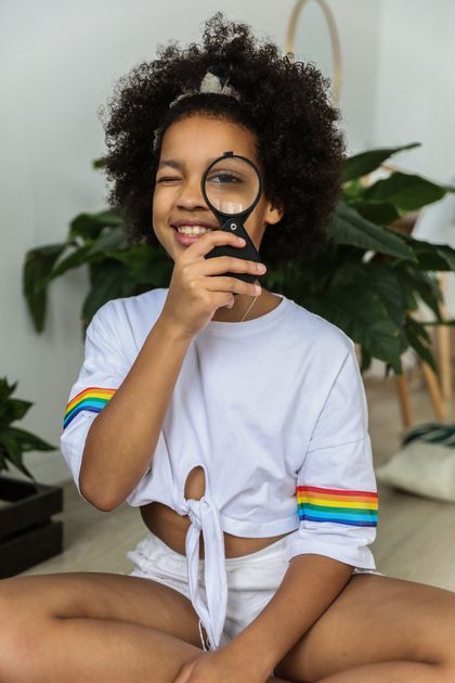 Image of girl looking through magnifying glass