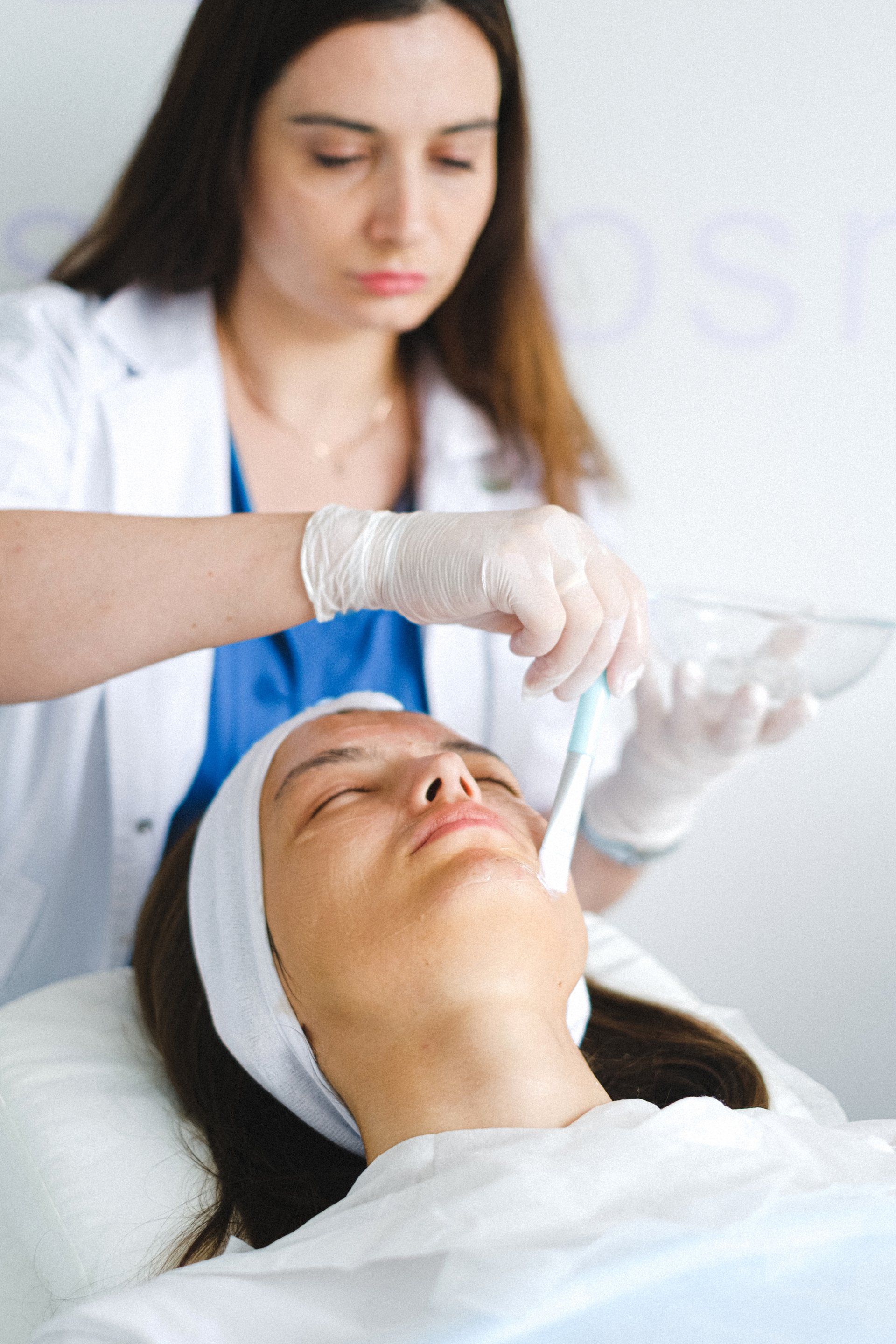 A woman is getting a facial treatment at a beauty salon.