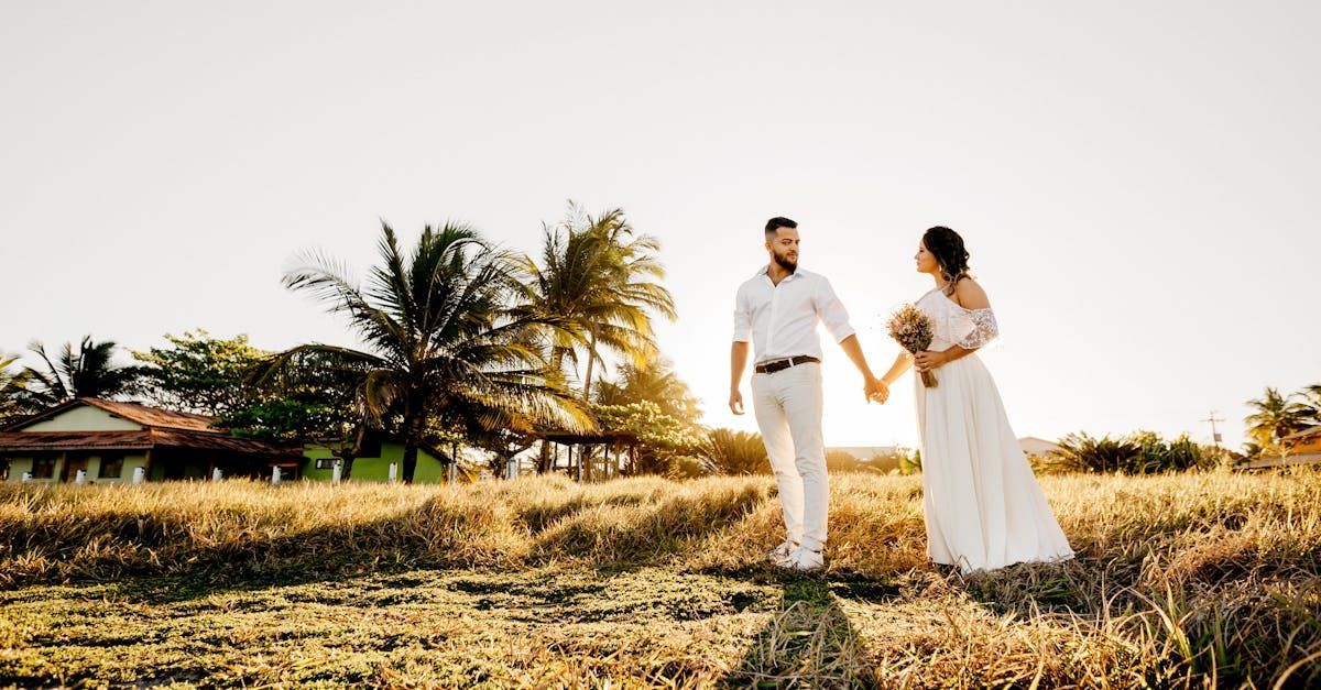 A couple in wedding attire on the grass of Jamaica 