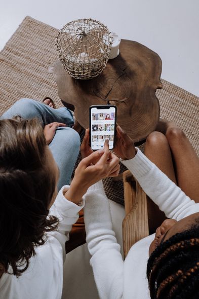 Image of two women looking at social media on one phone