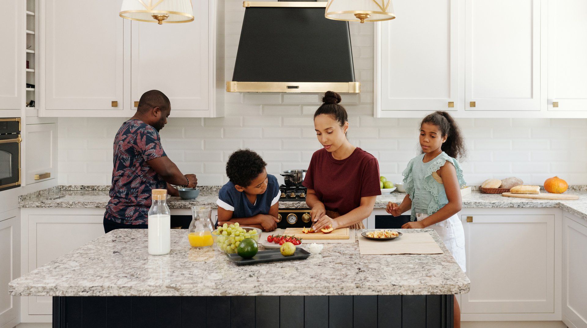 A family is cooking together in a kitchen.