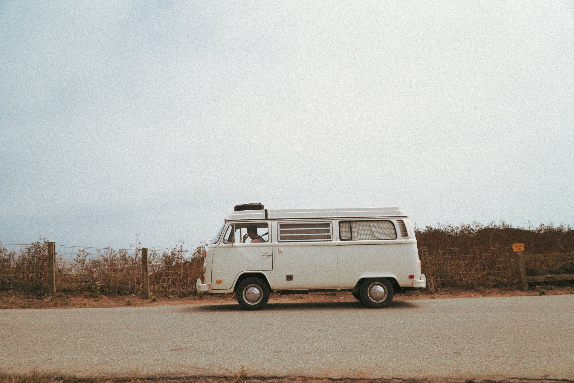 White VW Kombi parked on side of the road