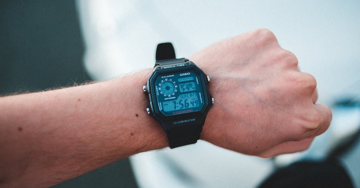 a person is wearing a digital watch on their wrist .