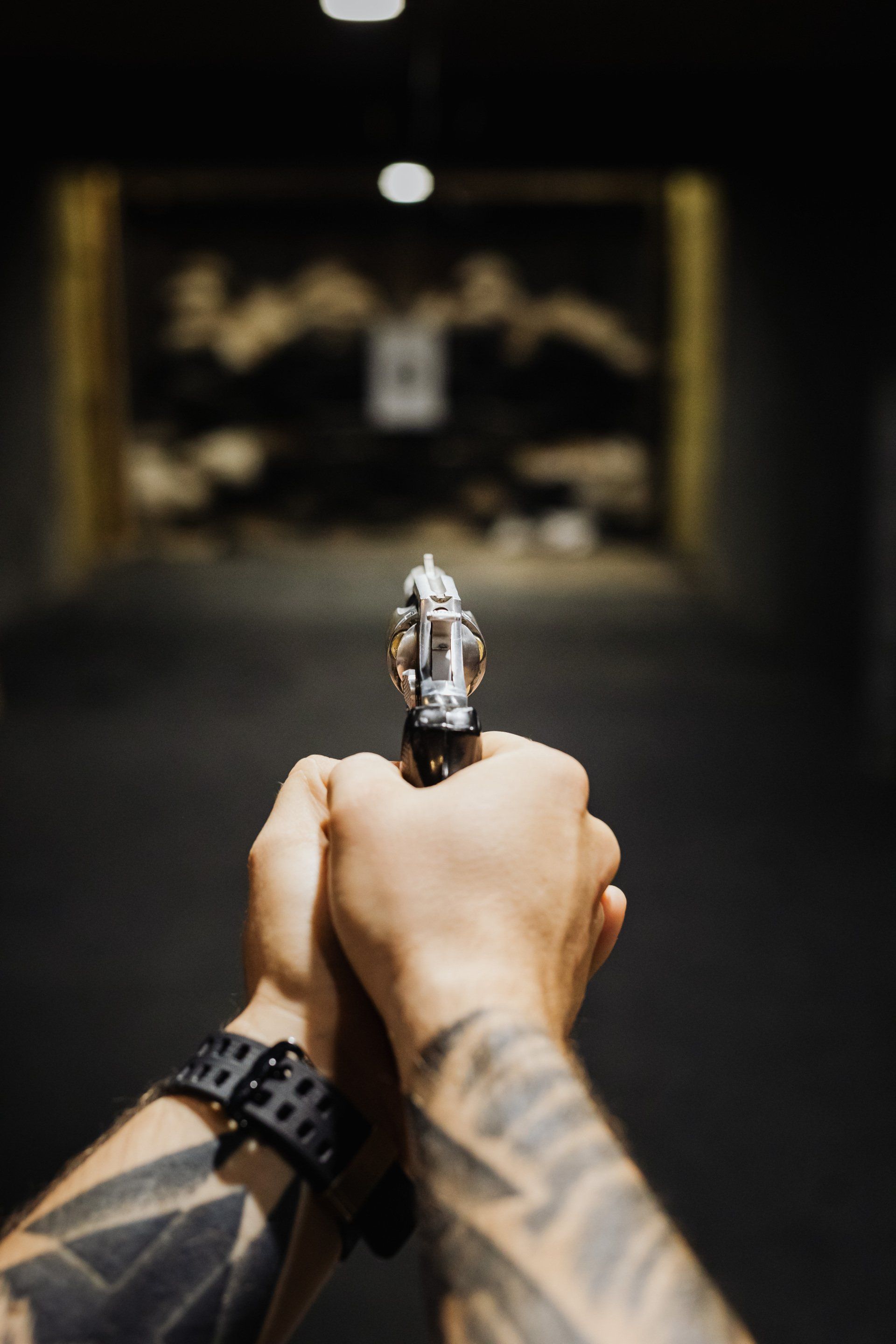 a hand holding a gun .
