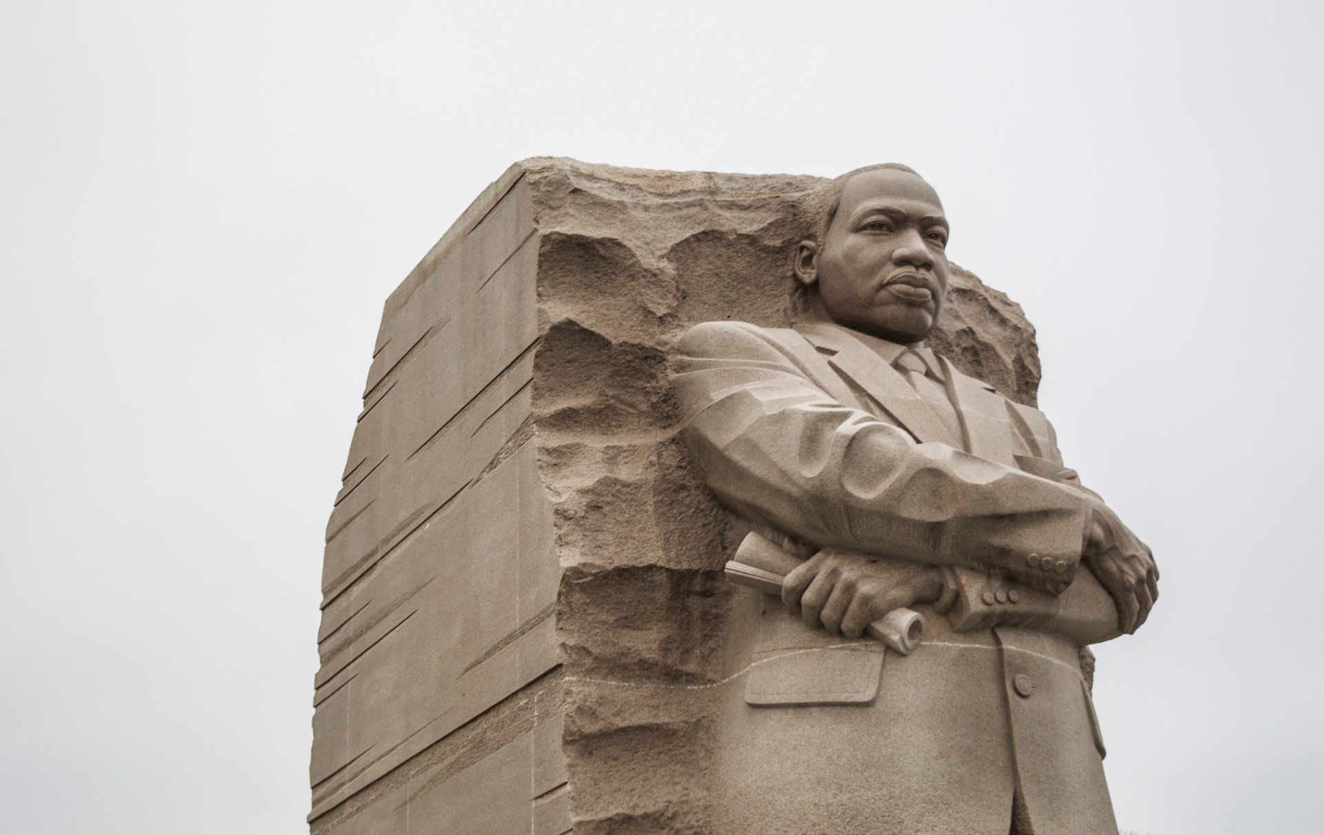 A statue of martin luther king jr. with his arms crossed.