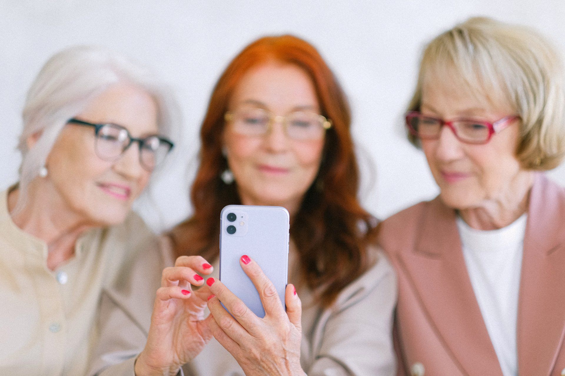Three ladies engaging with a social media post