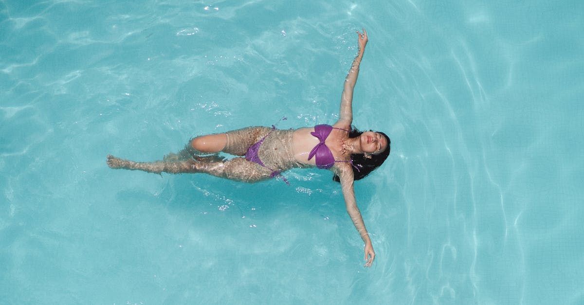 A woman floating on her back in the Belamy rooftop swimming pool.