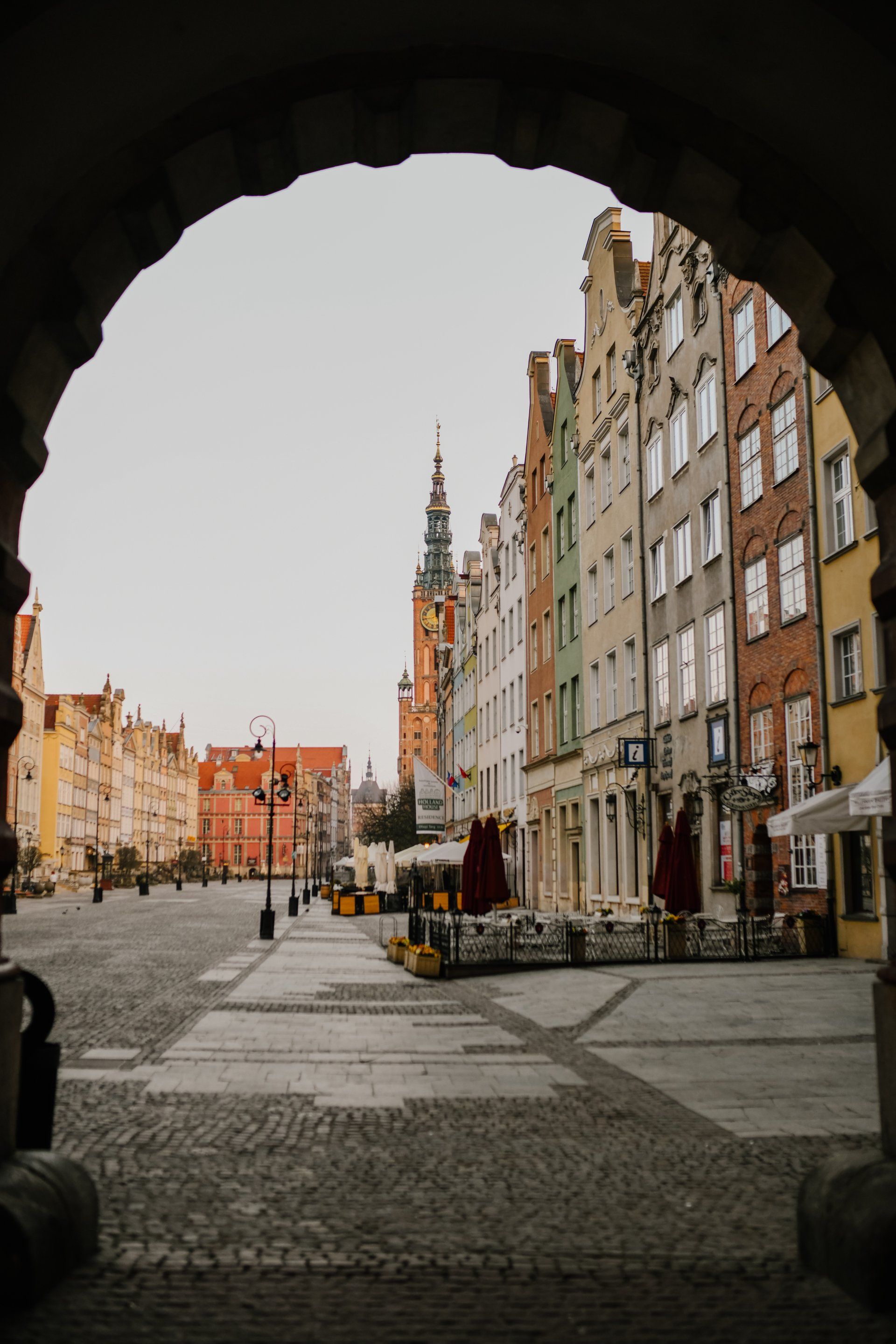 A view of a city street through an archway.