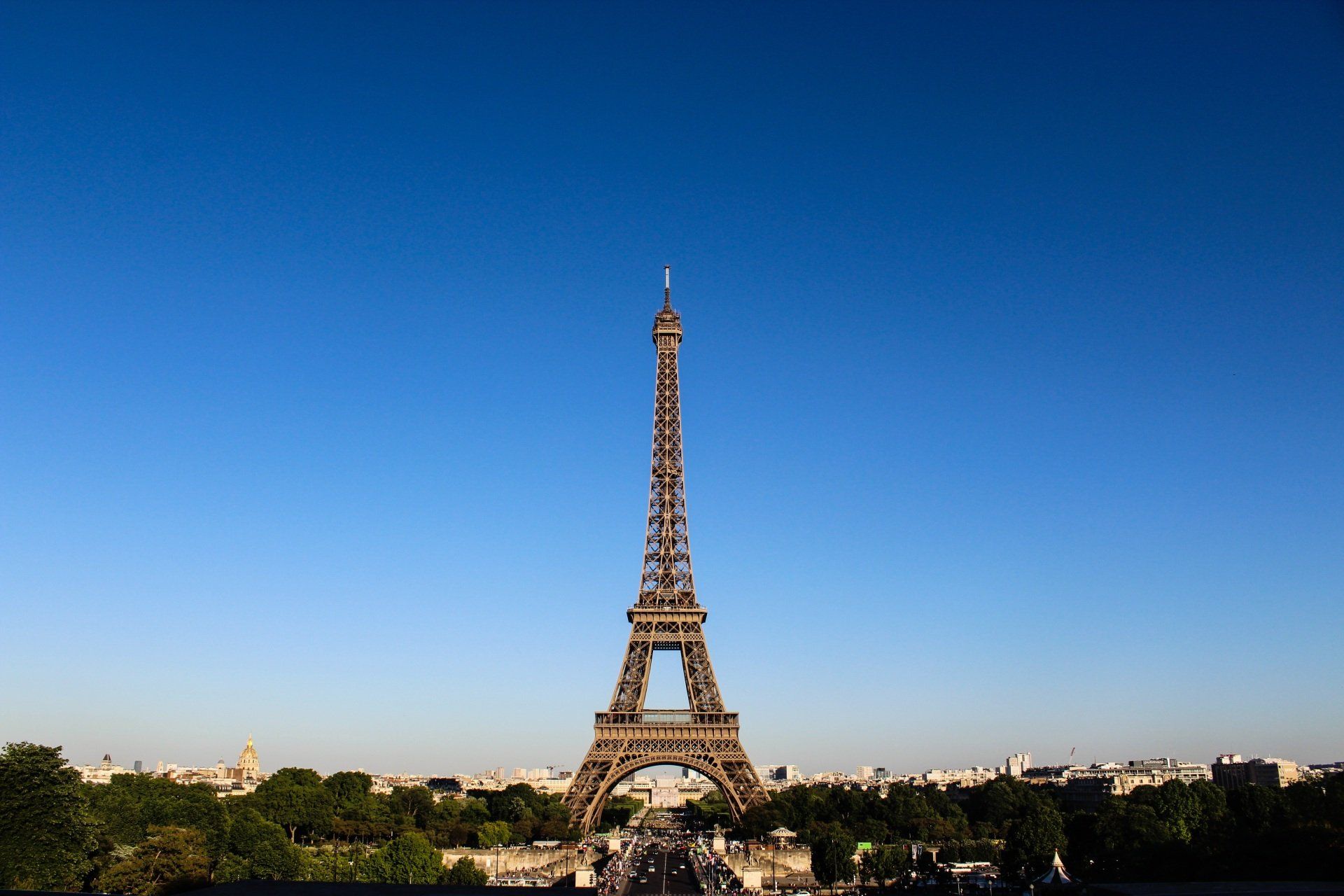 The eiffel tower is against a blue sky in paris