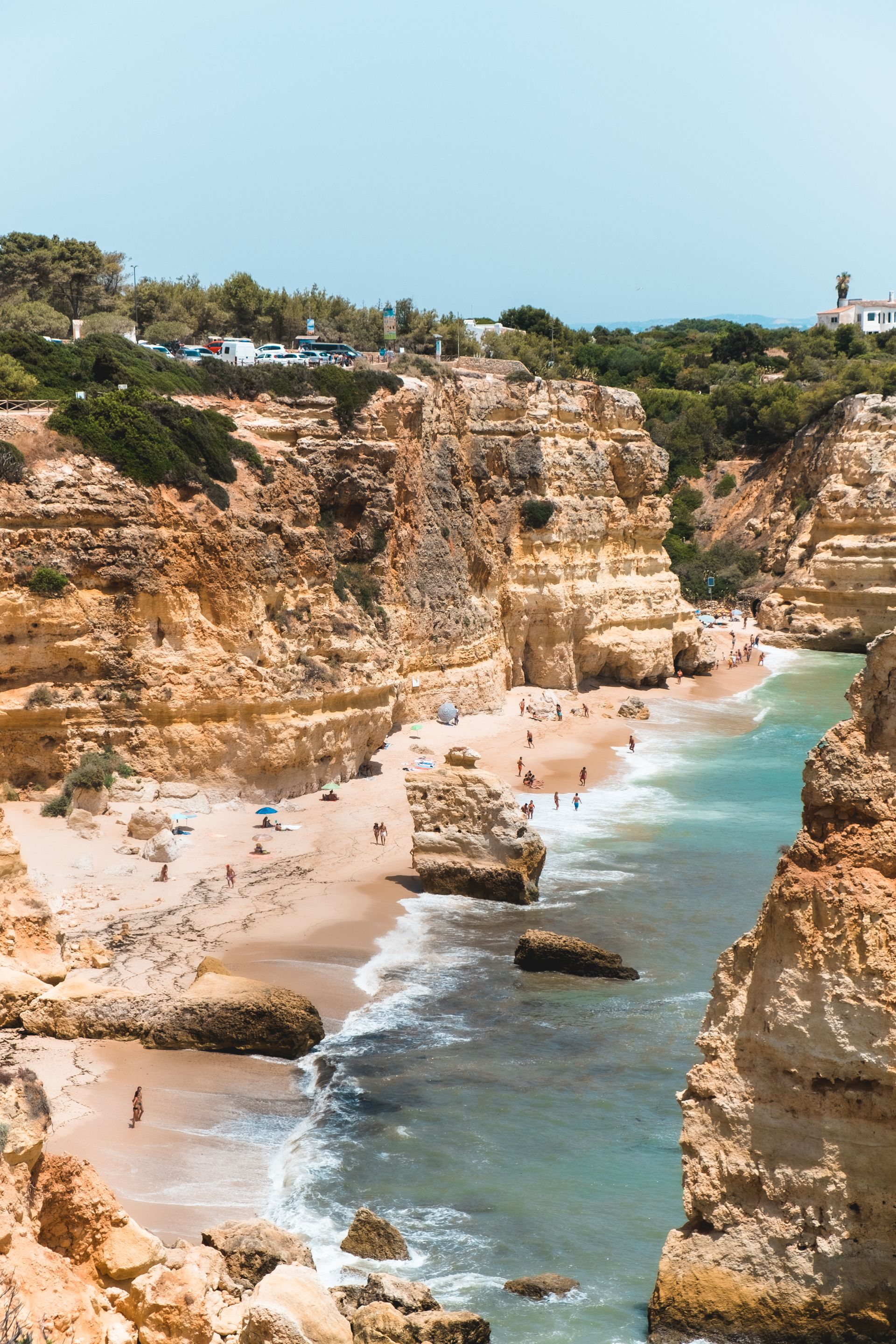 A view of a beach from the top of a cliff.