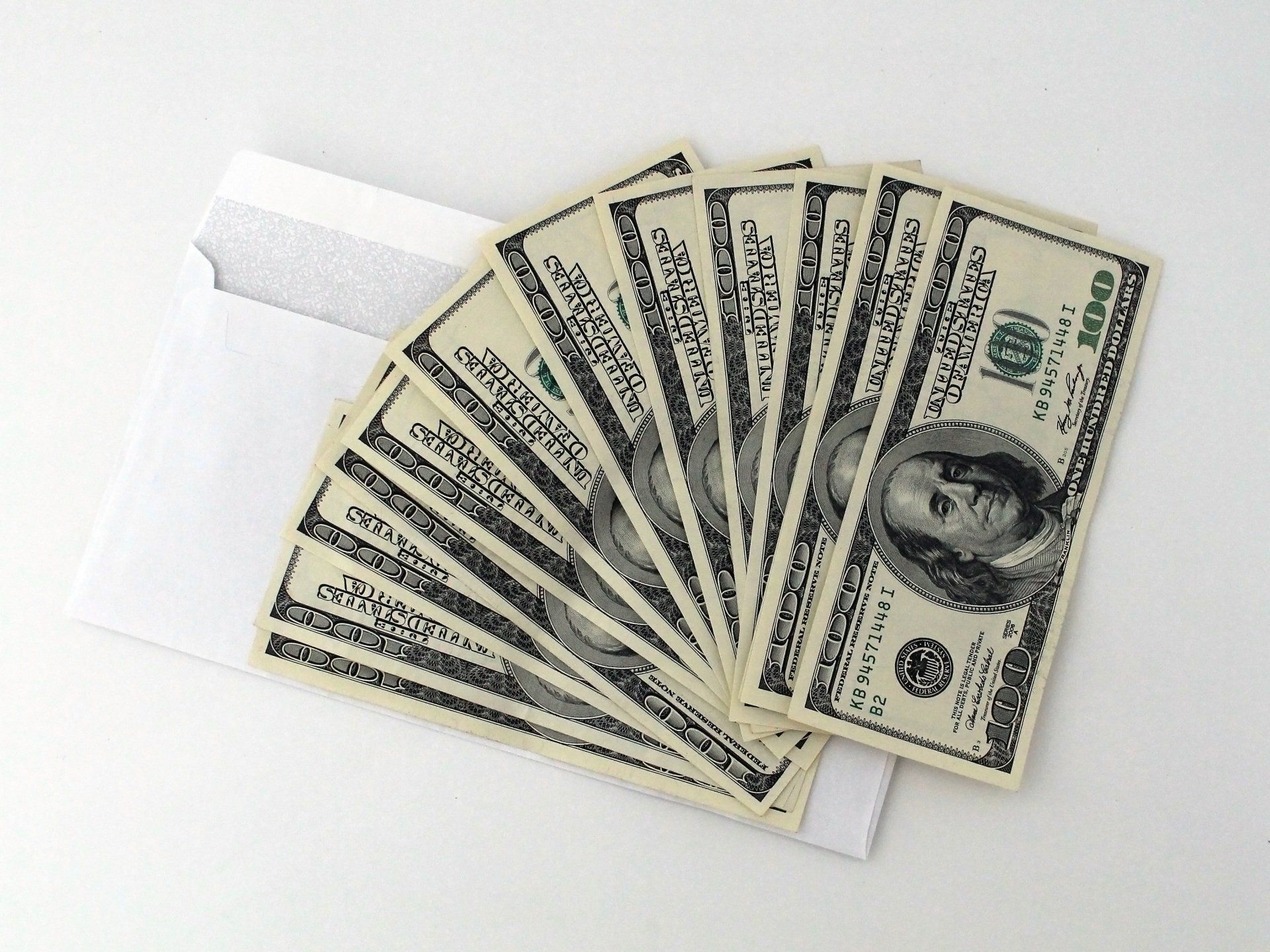 A fan of twenty dollar bills in an envelope