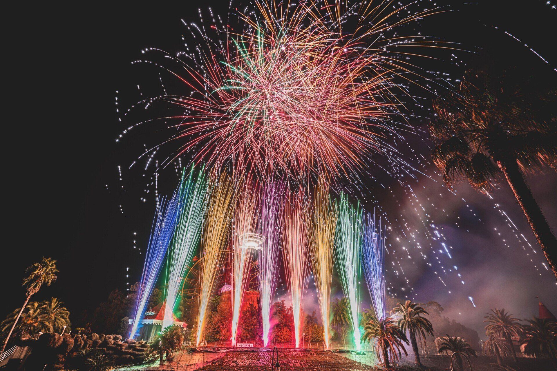 Sparkling fireworks in the night sky in multiple different colors