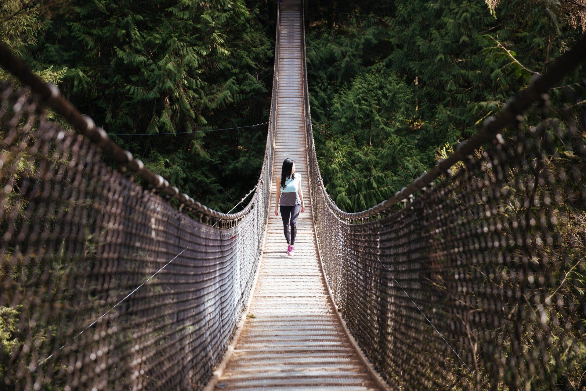 woman on rope bridge