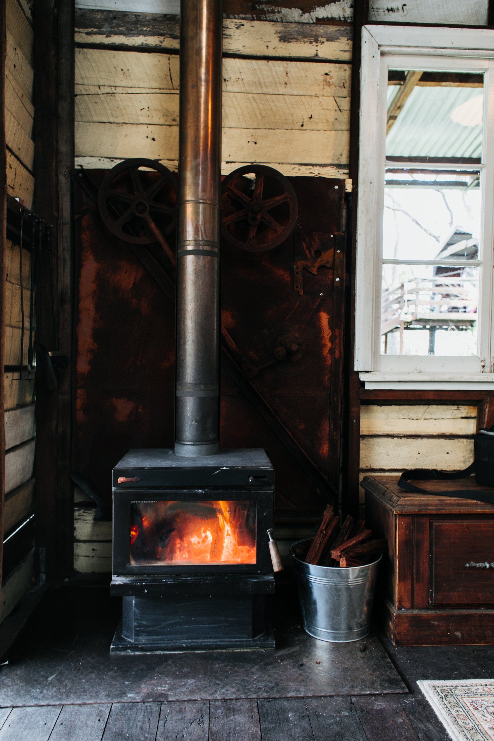 old-fashioned fireplace and bucket of water