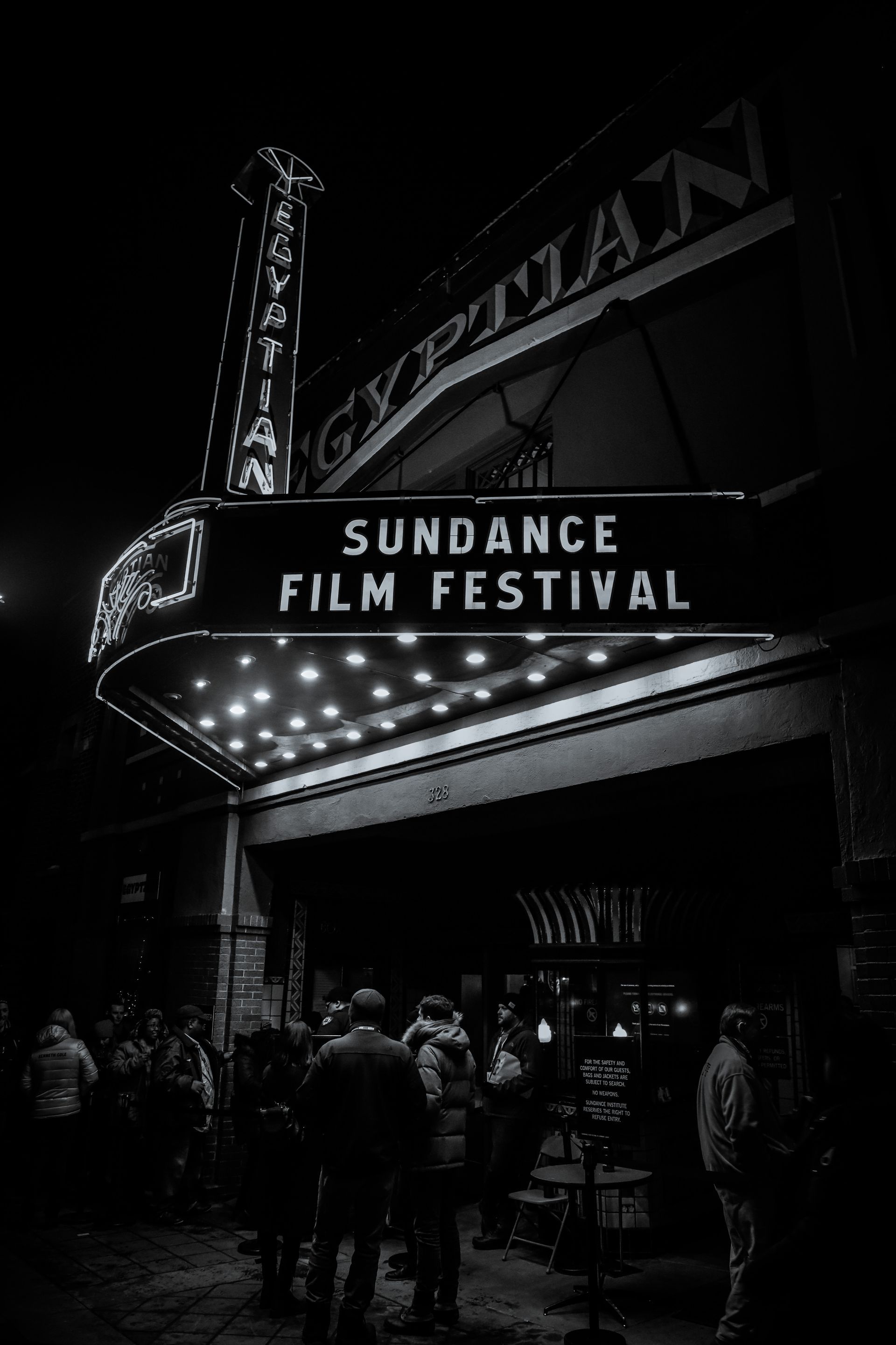 A black and white photo of a movie theater with a sign that says sundance film festival.