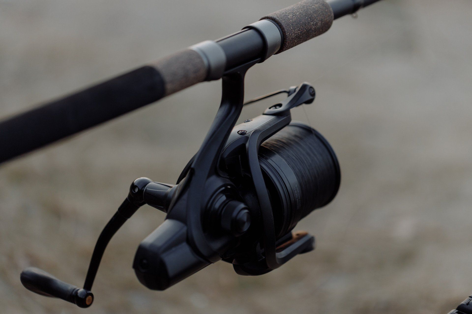 A fishing rod with a spinning reel attached to it.