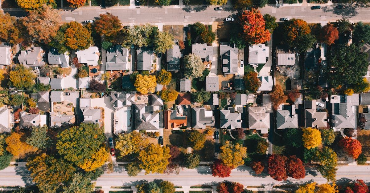 an aerial view of a residential neighborhood in autumn