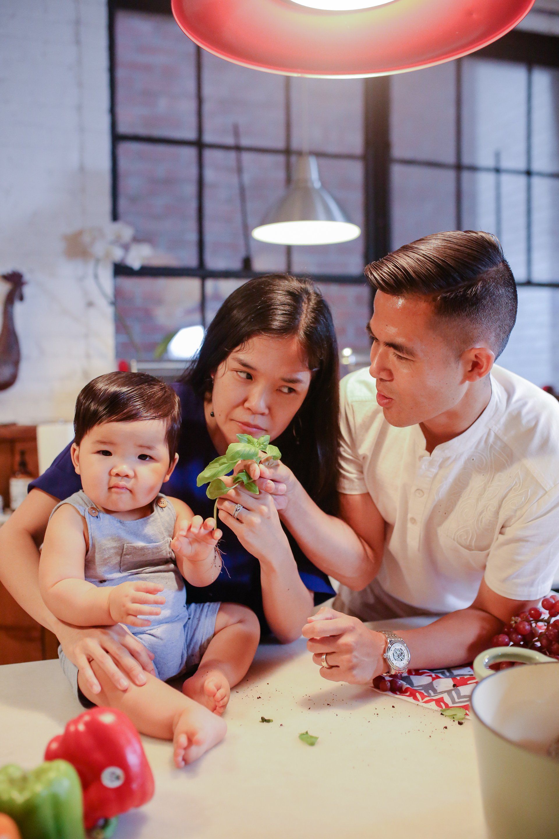 A family is sitting at a table eating vegetables.