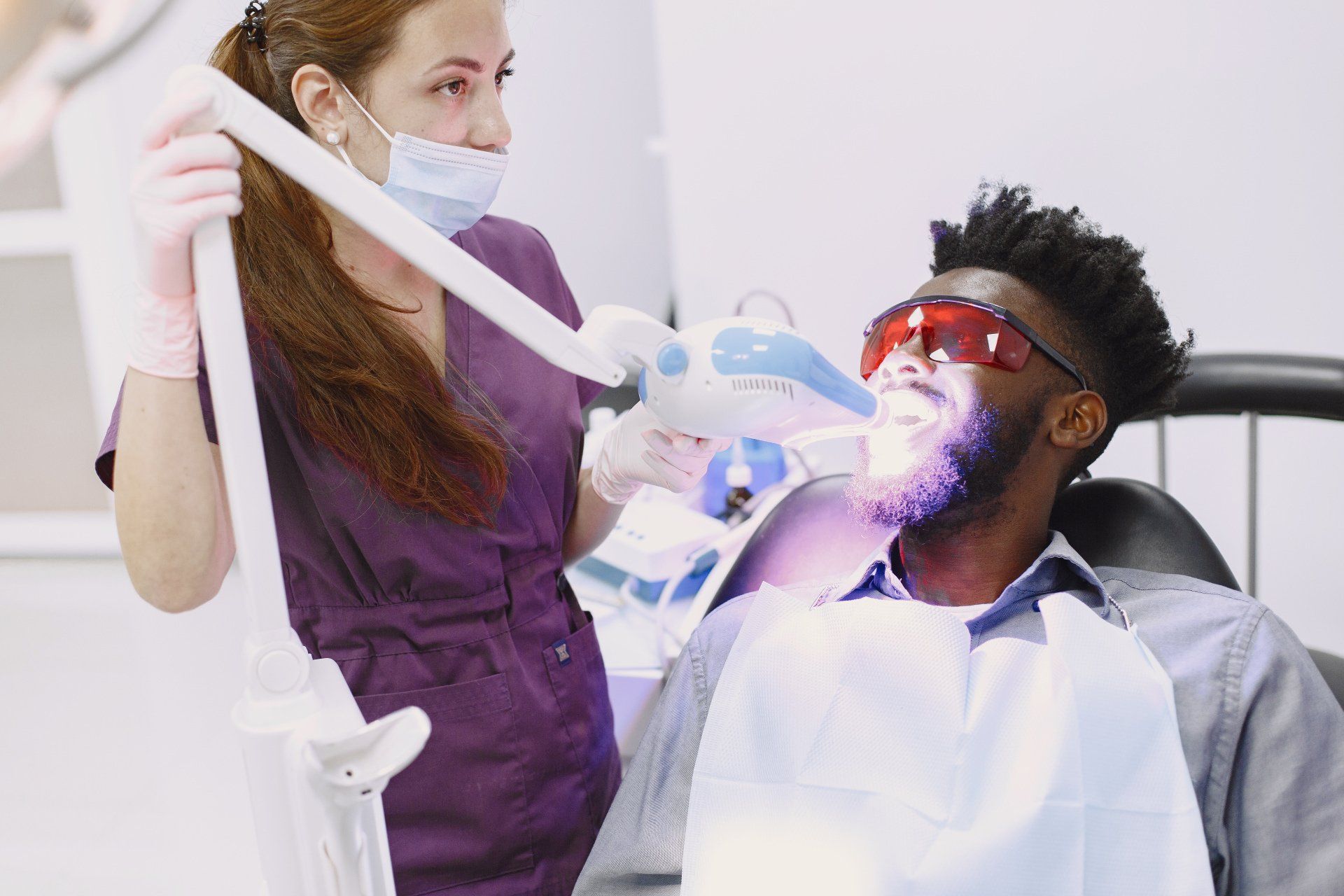 man receiving tooth whitening treatment