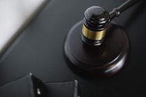 A close up of a judge 's gavel on a table.