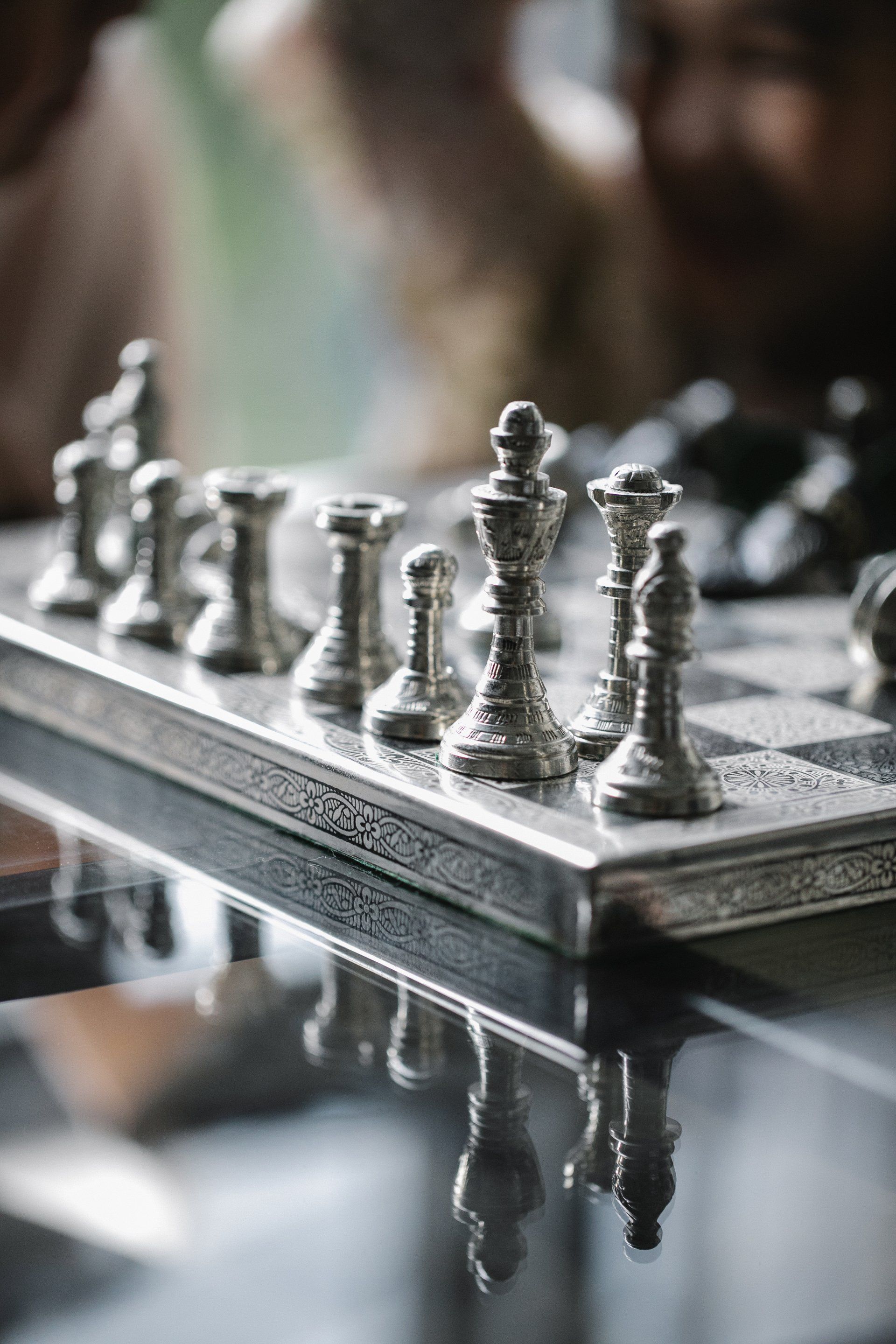 A close up of a chess board with chess pieces on it.