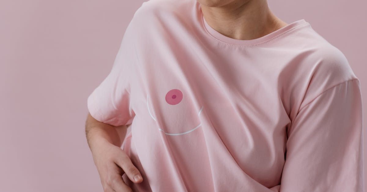 Woman wearing pink shirt with nipple drawn on it.