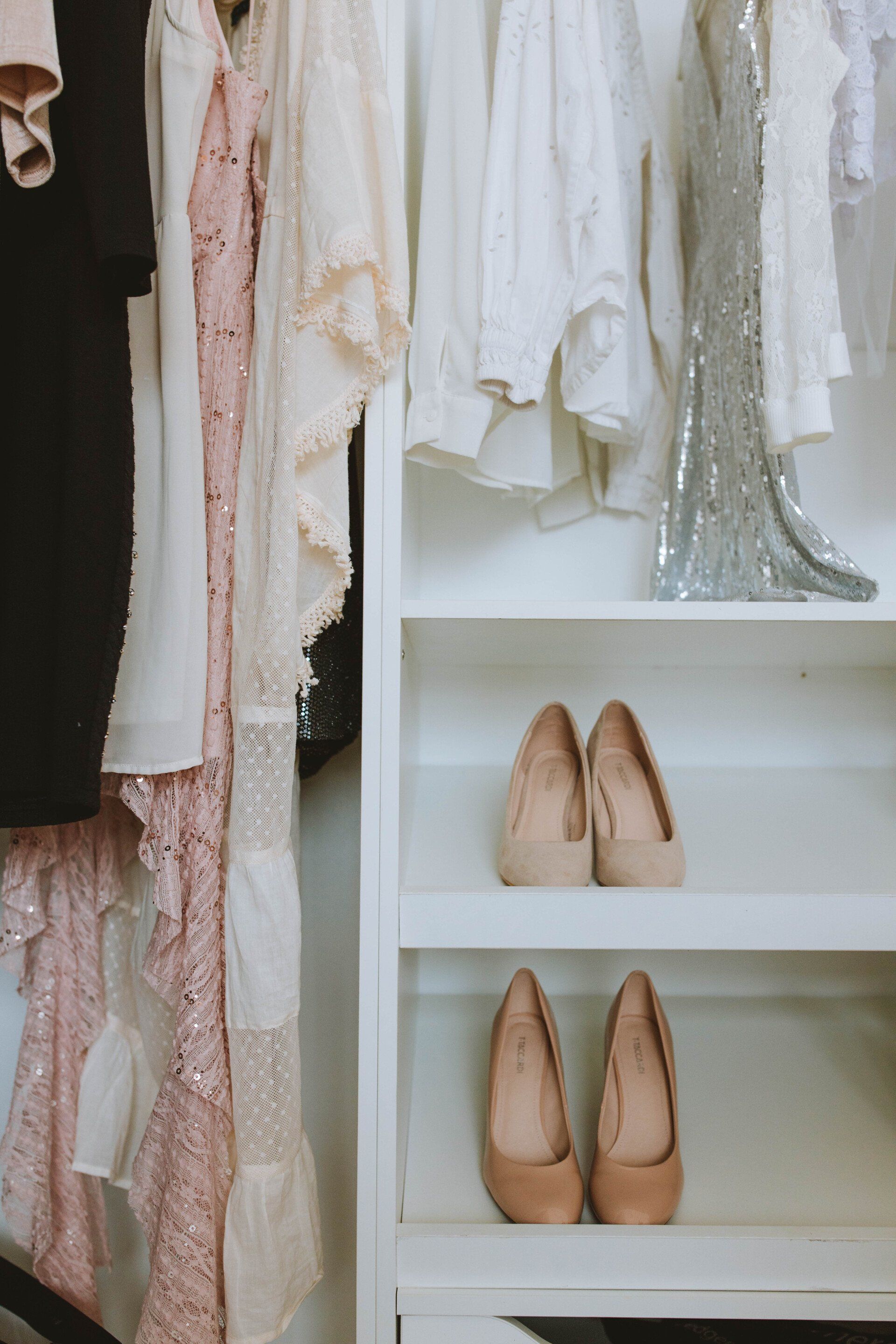 A closet filled with lots of clothes and shoes.