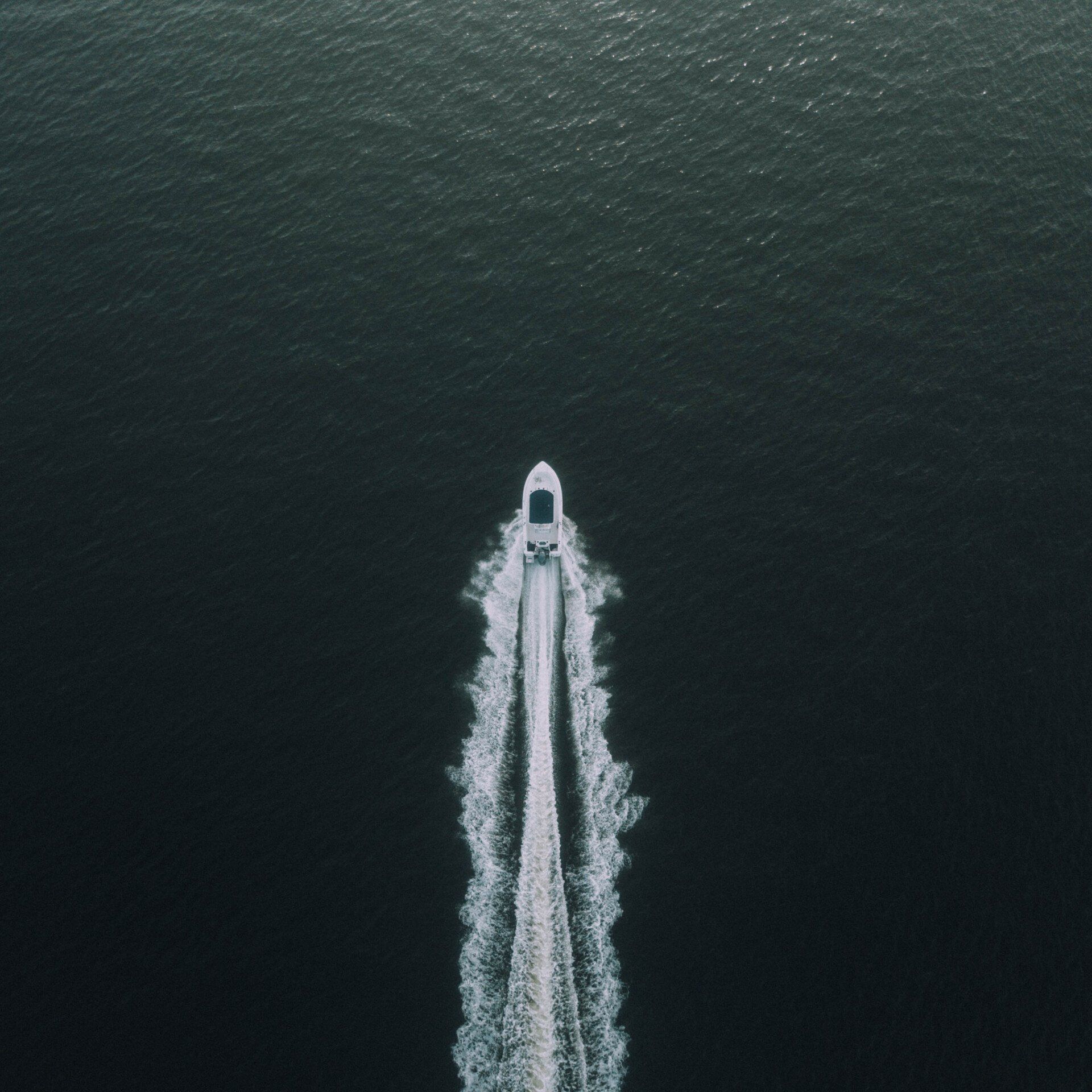 An aerial view of a boat in the ocean