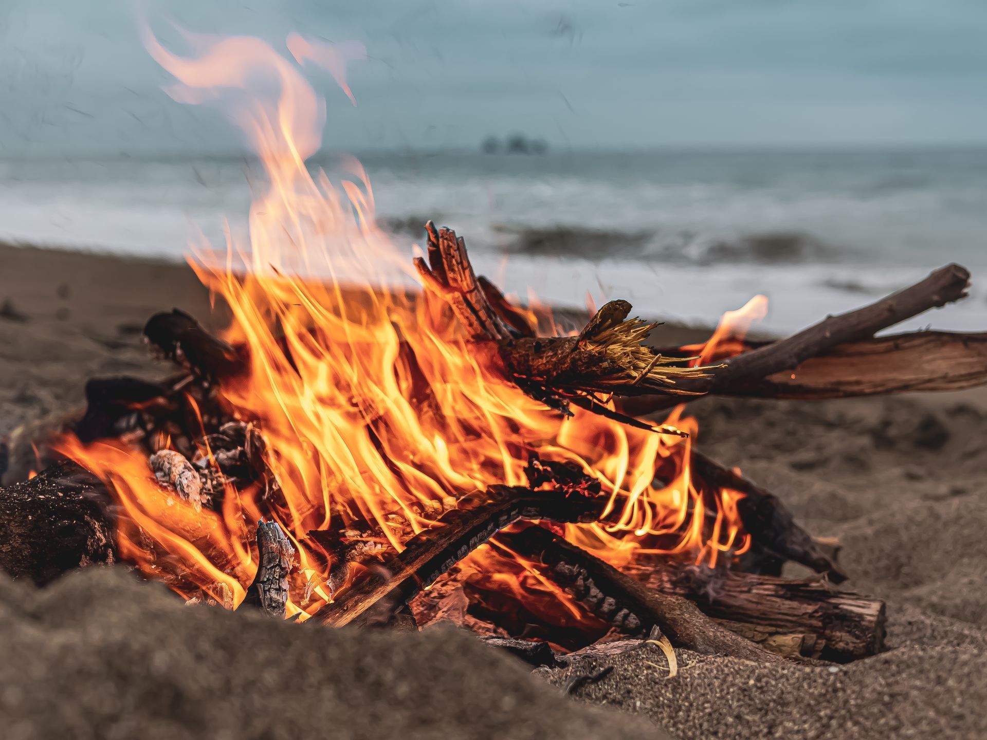 Bonfire on the beach with ocean in background