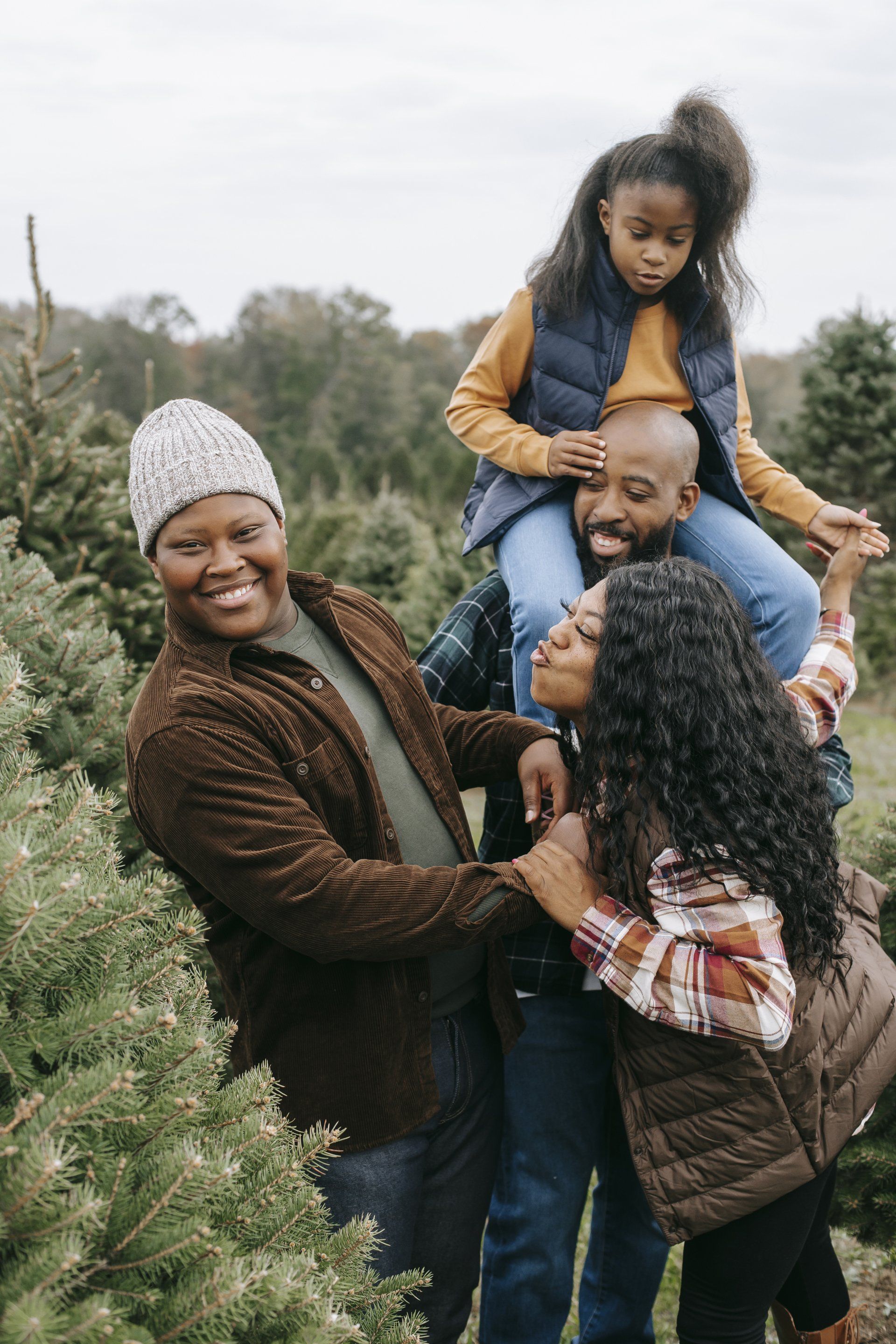 a family at a tree farm representing family counseling sessions at Healing Our Trauma KC