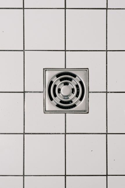 Floor drain on tile surface, commonly used in plumbing drain cleaning services