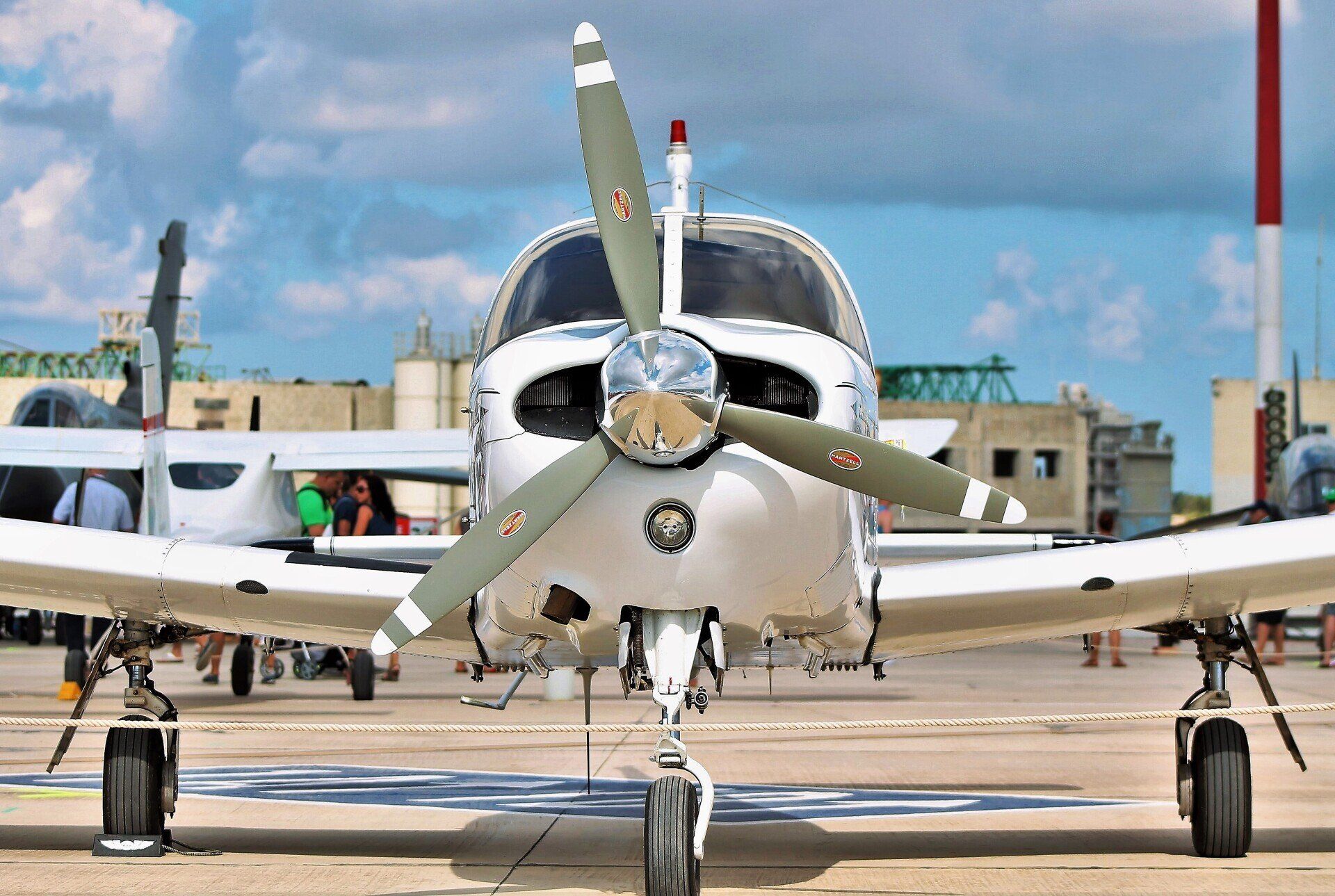 A small propeller plane is parked on a runway