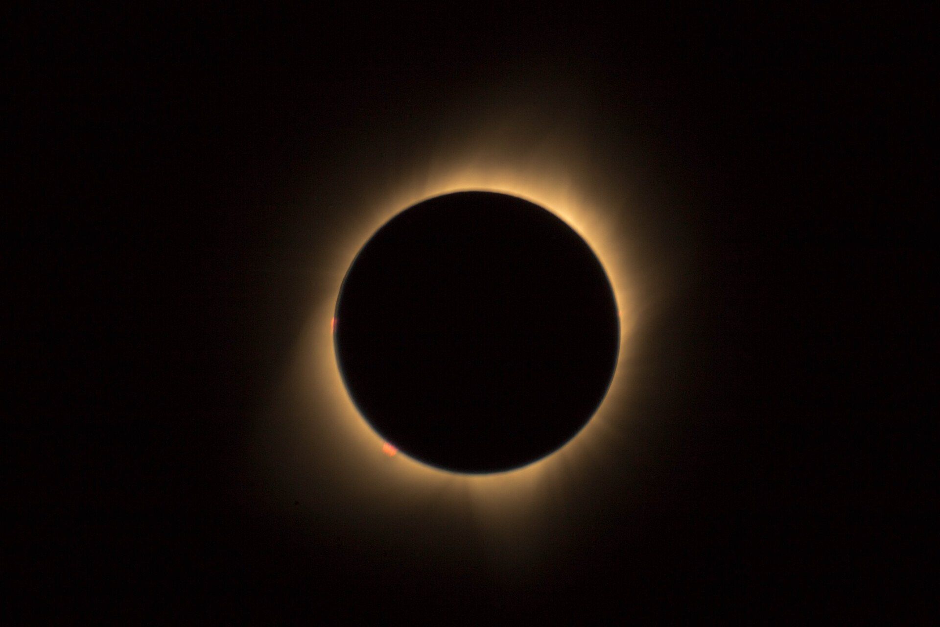The moon is covering the sun during a total eclipse.