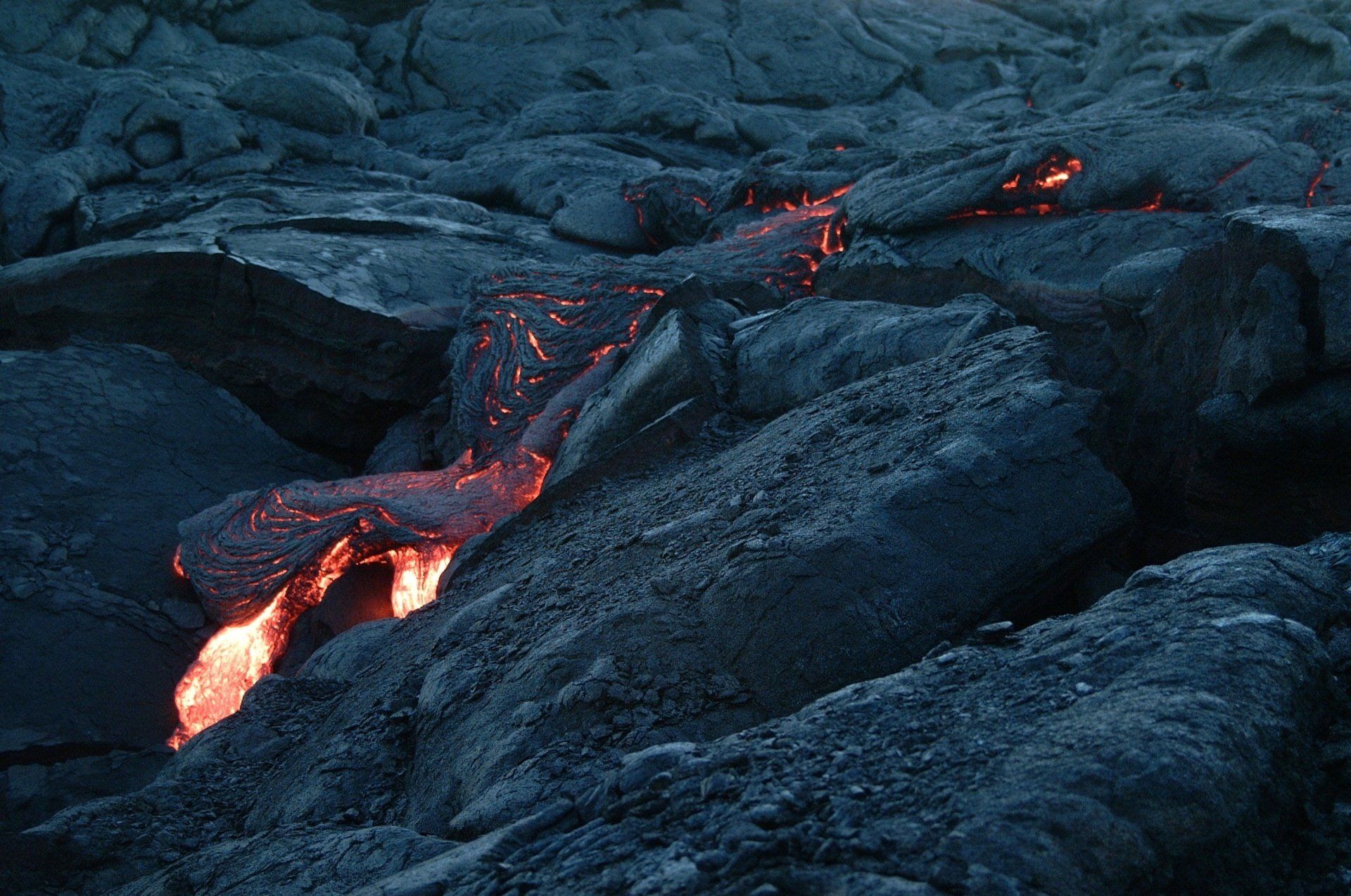 A large pile of rocks with lava coming out of them.