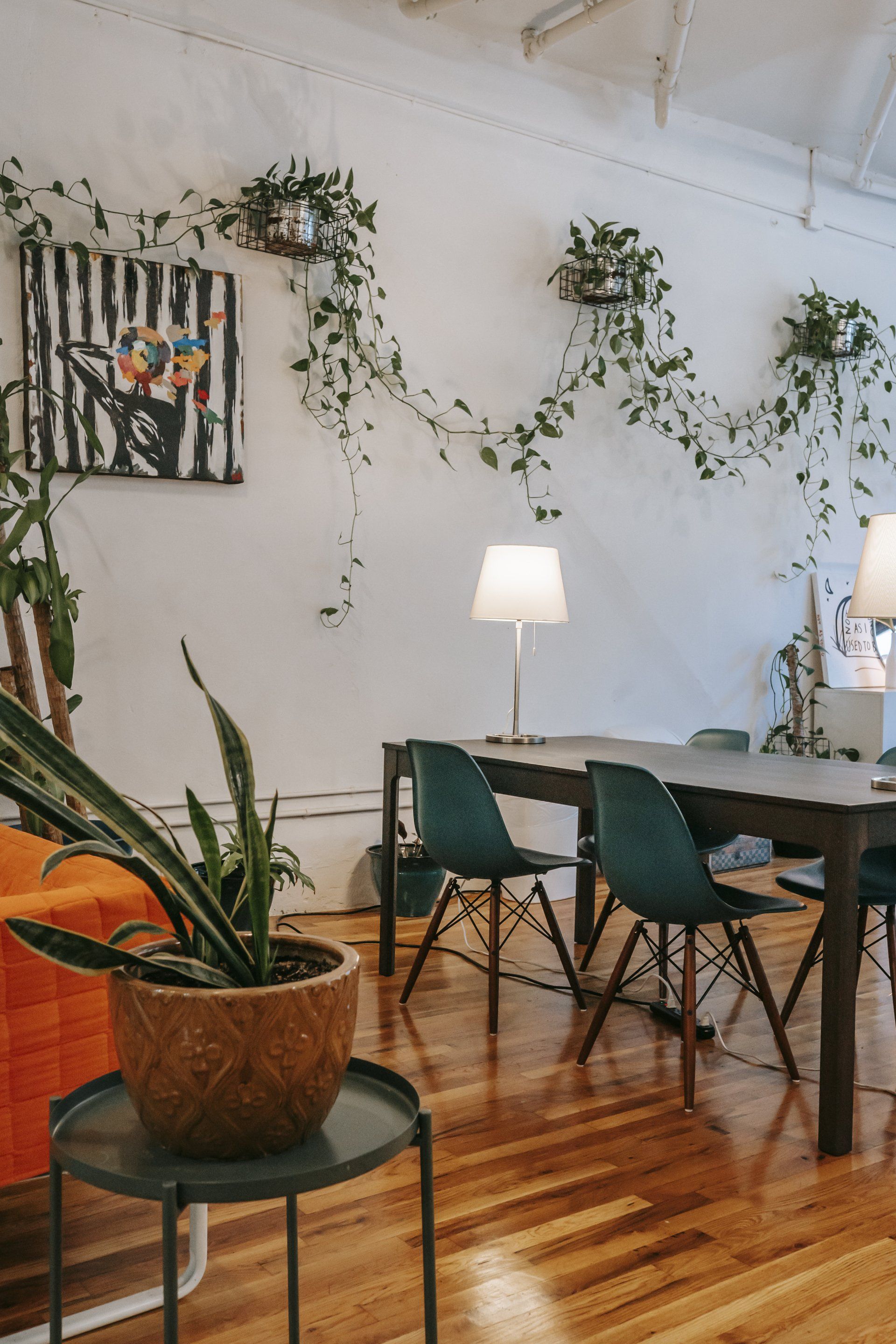 A room with a table and chairs and a potted plant on a table.