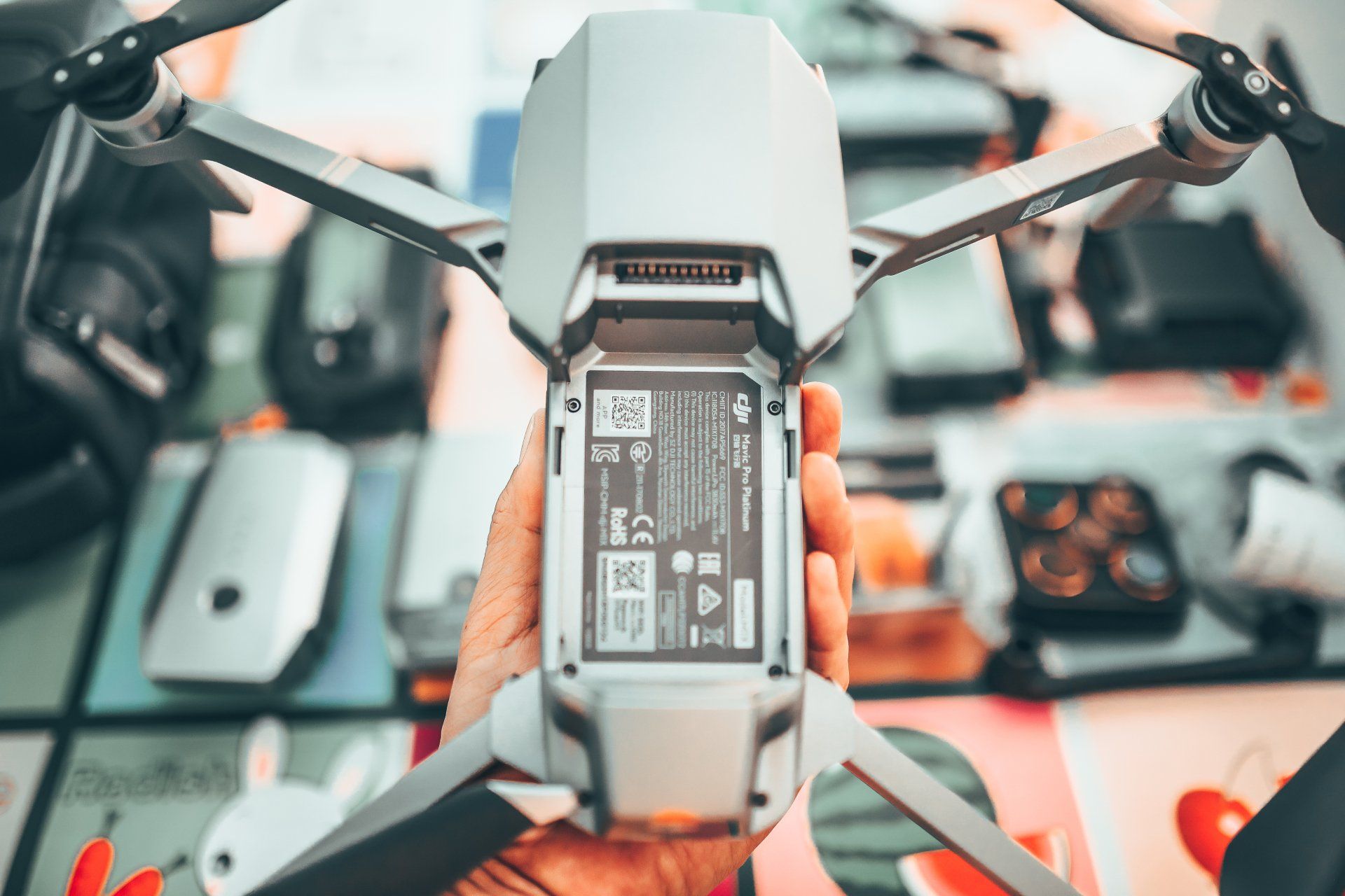 A drone, ideal for drone pilots, comfortably fits in the palm, displaying its compact and portable design for aerial photography or videography