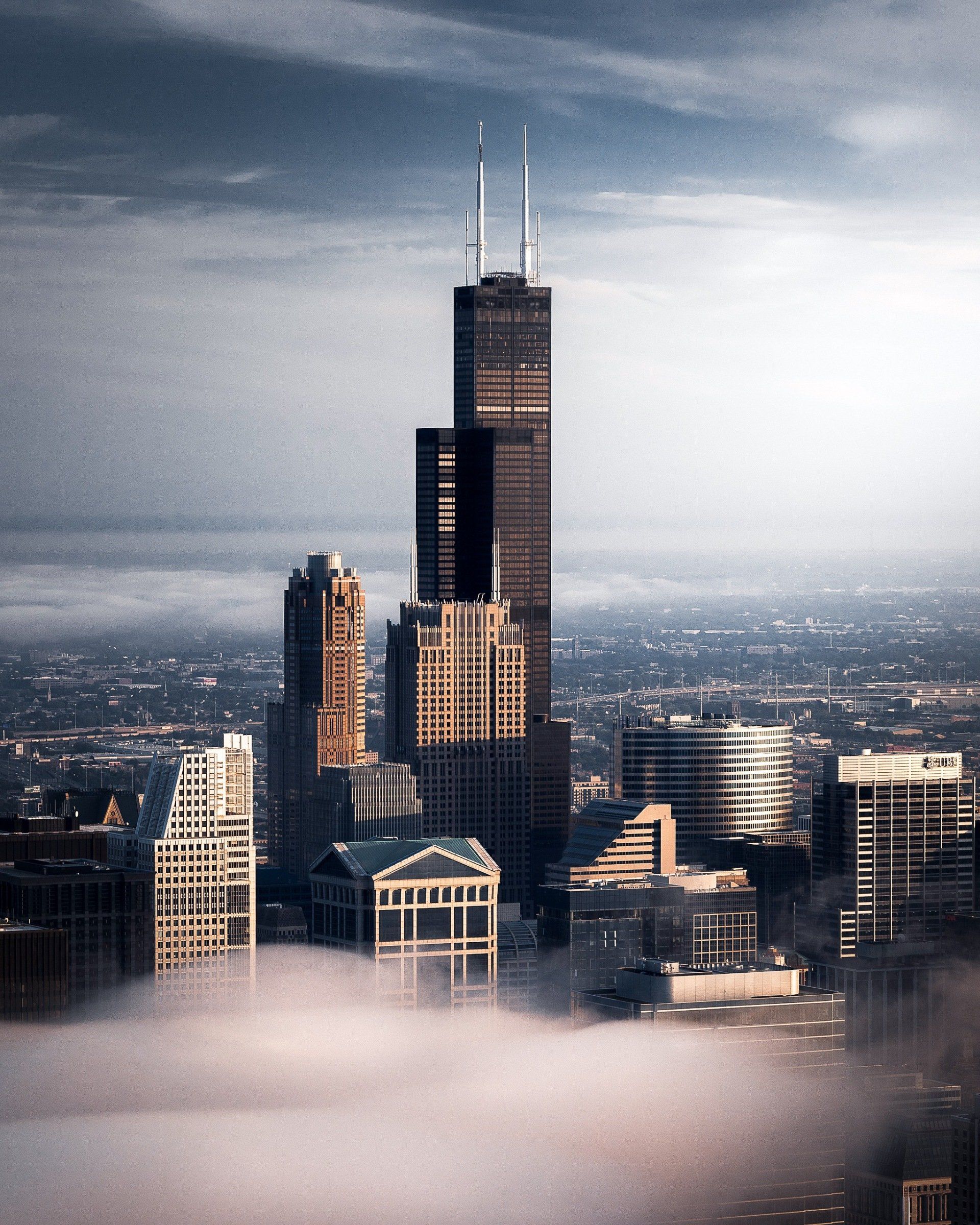 A city skyline with a few buildings covered in fog