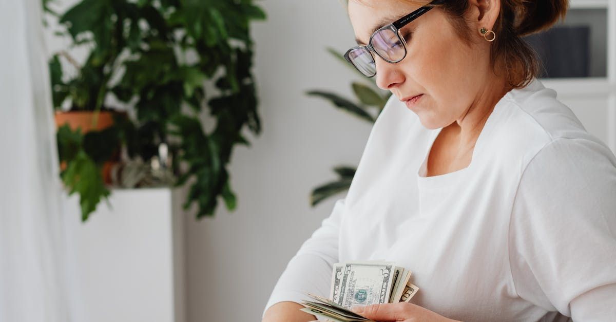 A woman is holding a bunch of money in her hands.