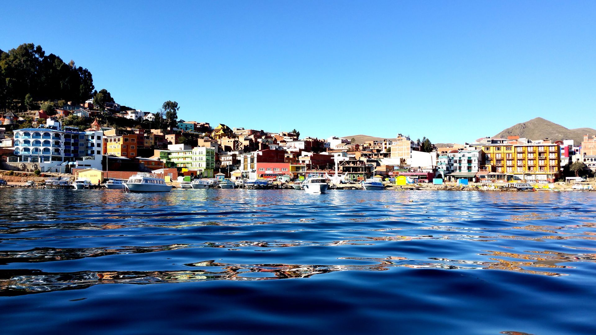 A city is visible in the distance behind a body of water.